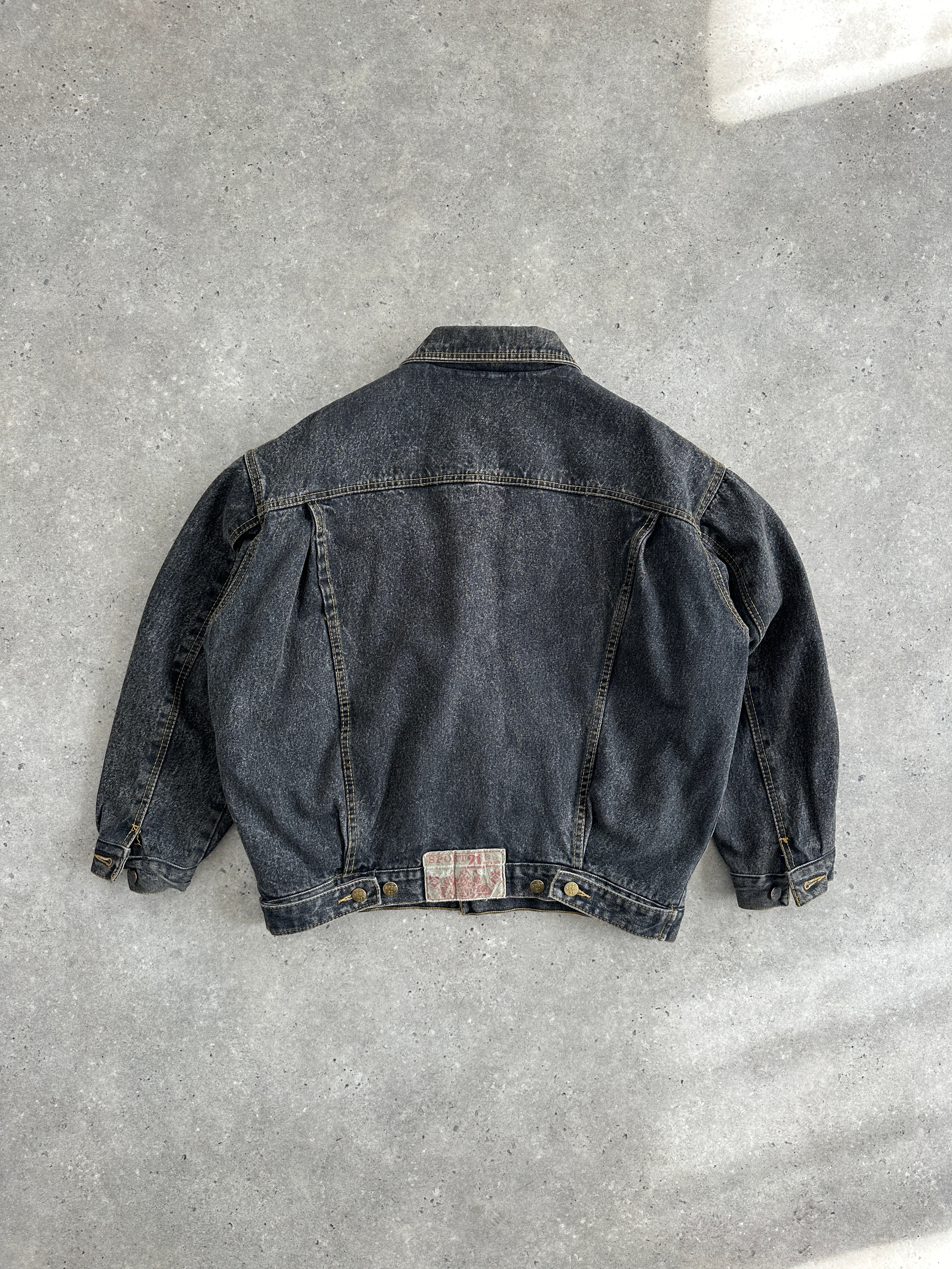 Vintage 1990s boxy denim jacket, size M, with classic wash and relaxed fit, featuring traditional collar and button closure.