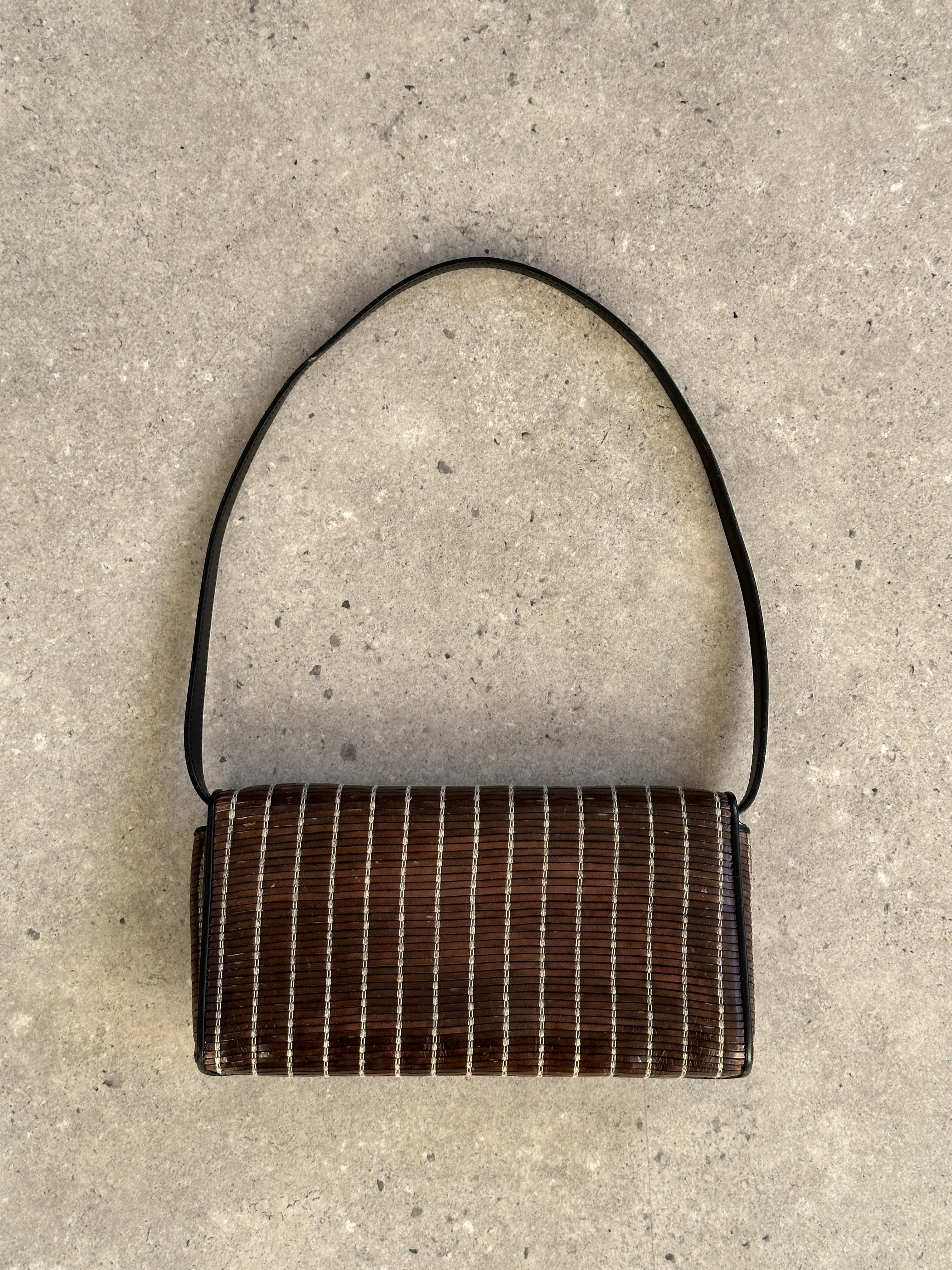 Giorgio Armani leather handbag with sleek design and top handle, featuring subtle stitching and elegant finish.