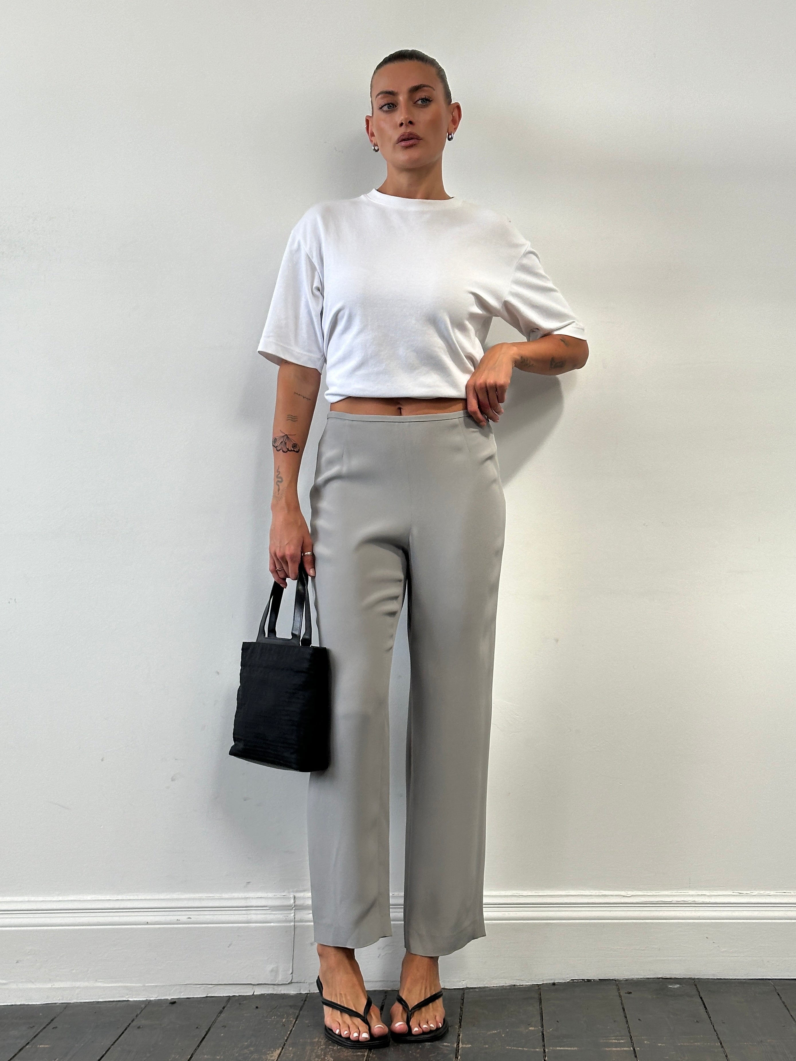 Armani Collezioni relaxed high-waisted silk trousers in black, with a tailored fit and subtle sheen, size W28.