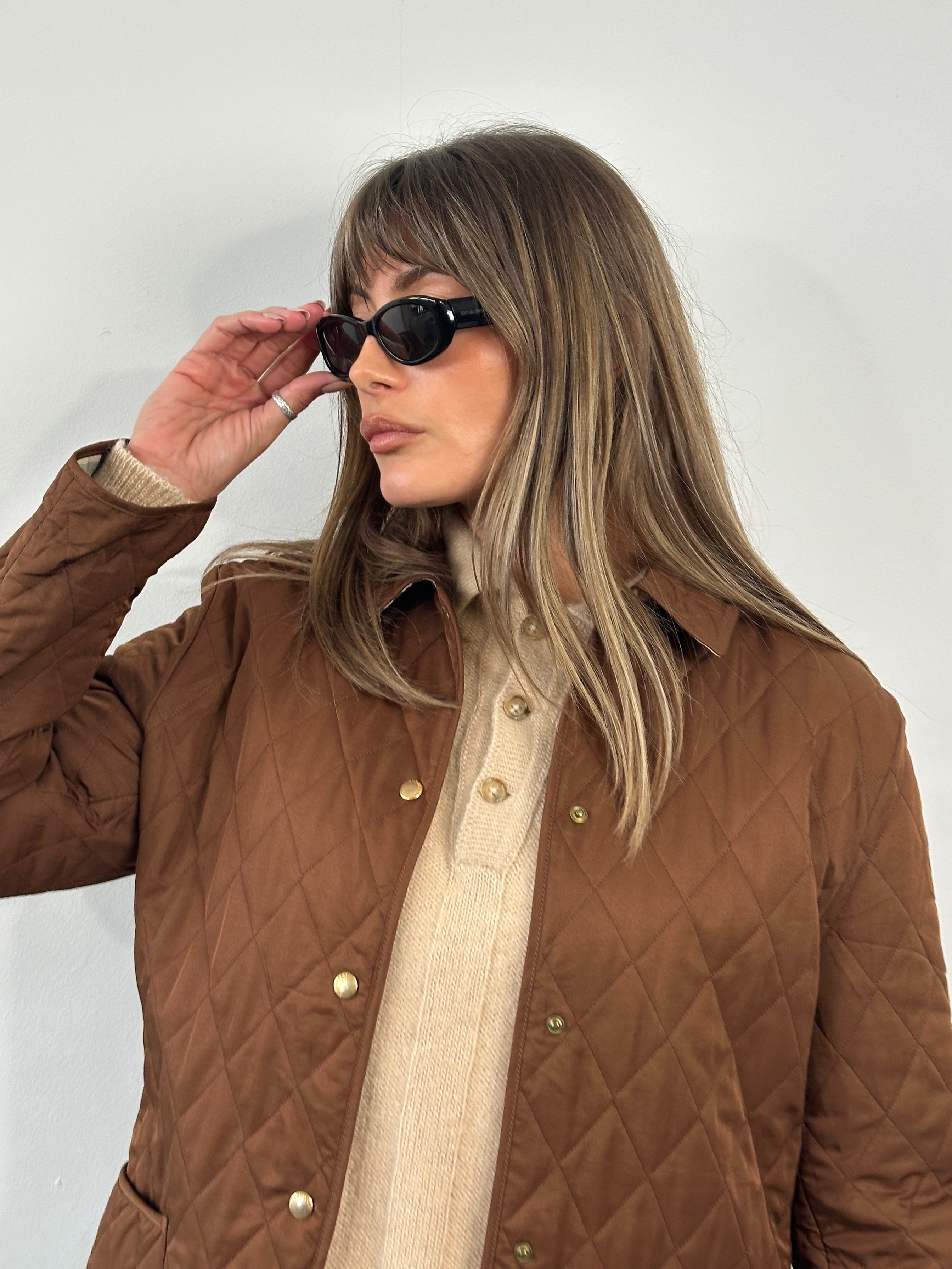 Burberry 2000s Quilted Nova Check jacket in size M, featuring classic check pattern and quilted design, displayed on a hanger.