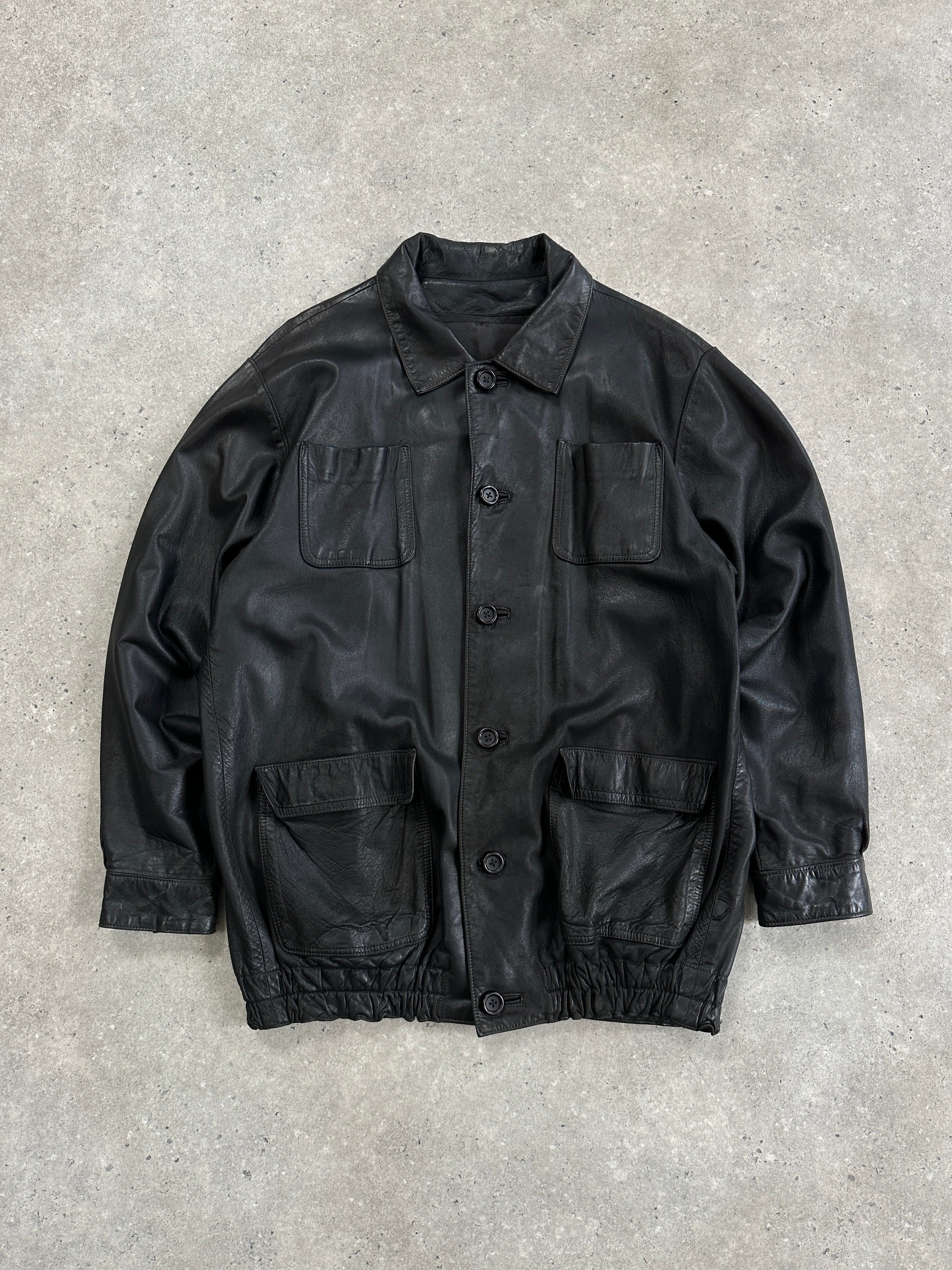 Vintage leather bomber jacket in XL size, featuring a minimal design with classic styling and a smooth leather finish.