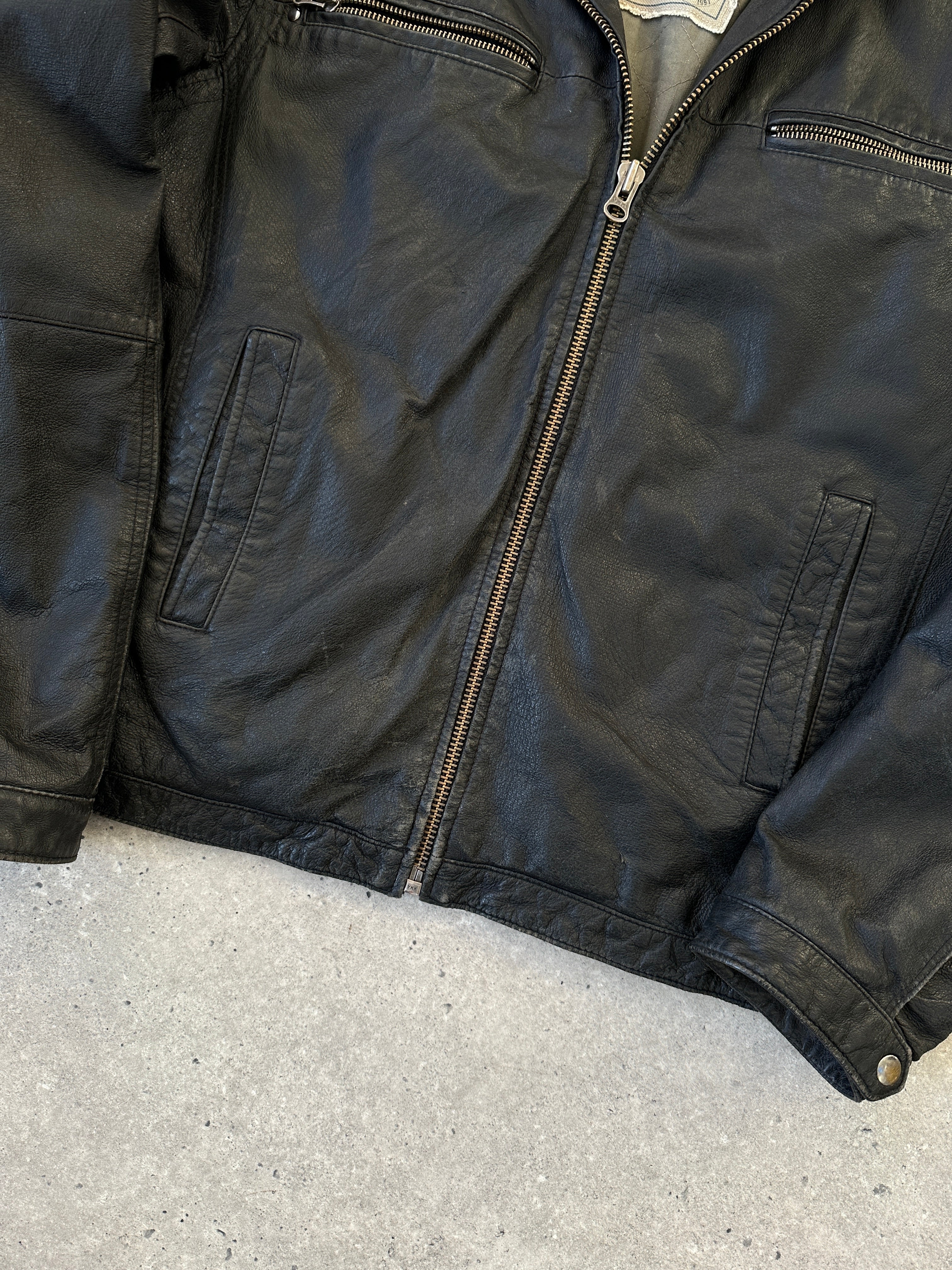 Vintage leather zip-up jacket in size large, featuring classic design with front zipper and collar detail.