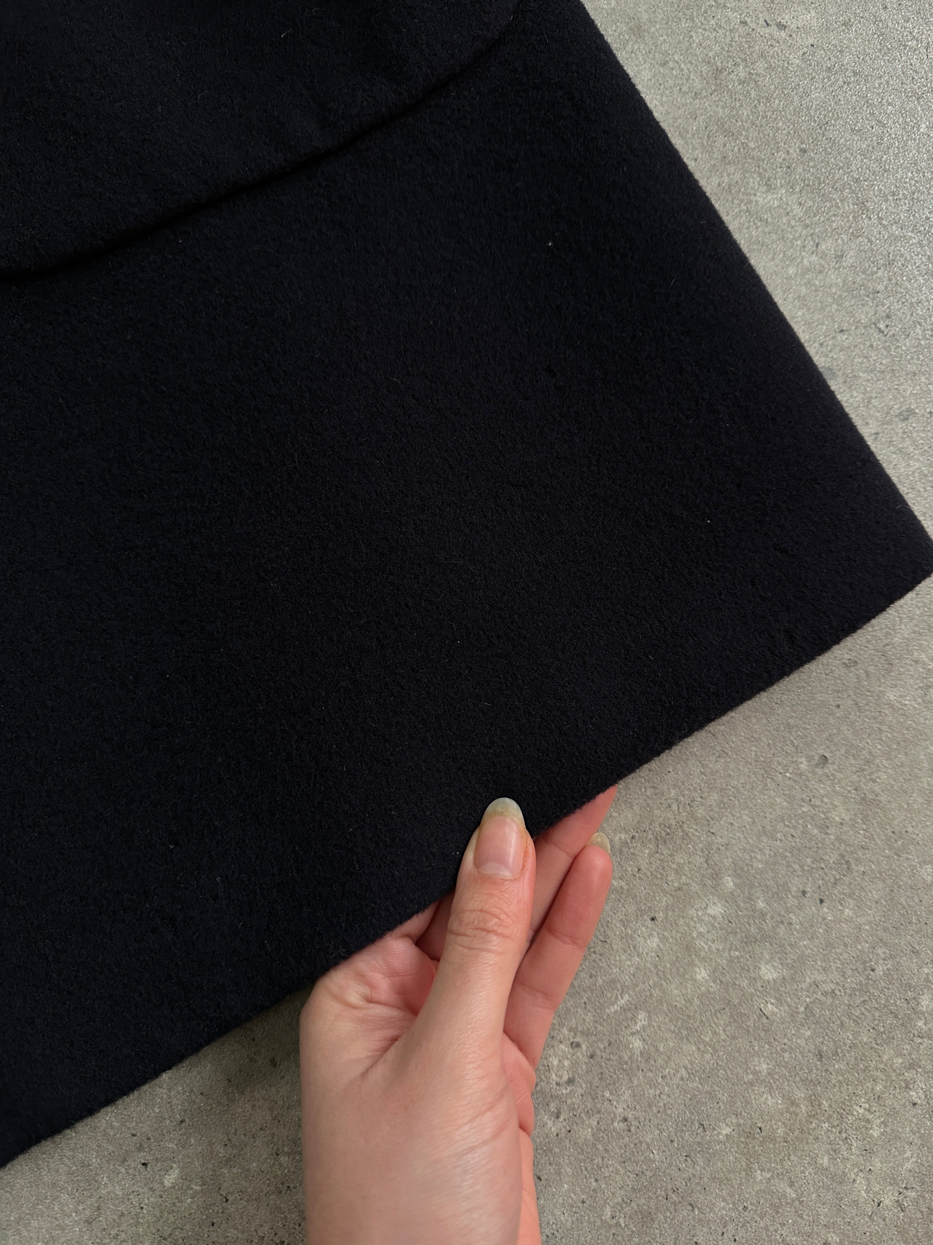 Vintage 1990s wool single-breasted coat in XL/XXL size, featuring classic design and textured fabric, displayed on a hanger.