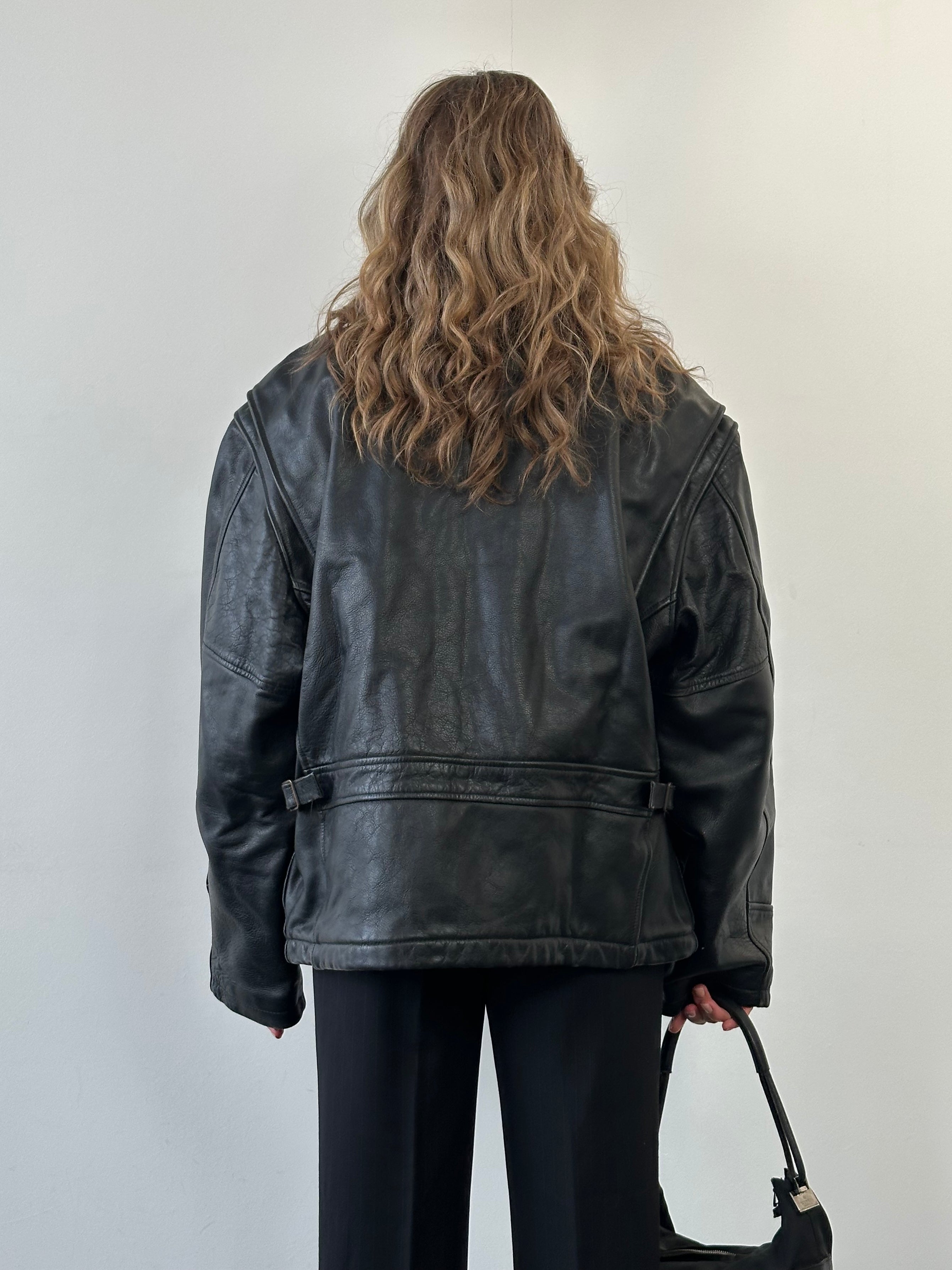Vintage fleece-lined leather jacket in size XL, showing classic design with warm interior and durable leather exterior.