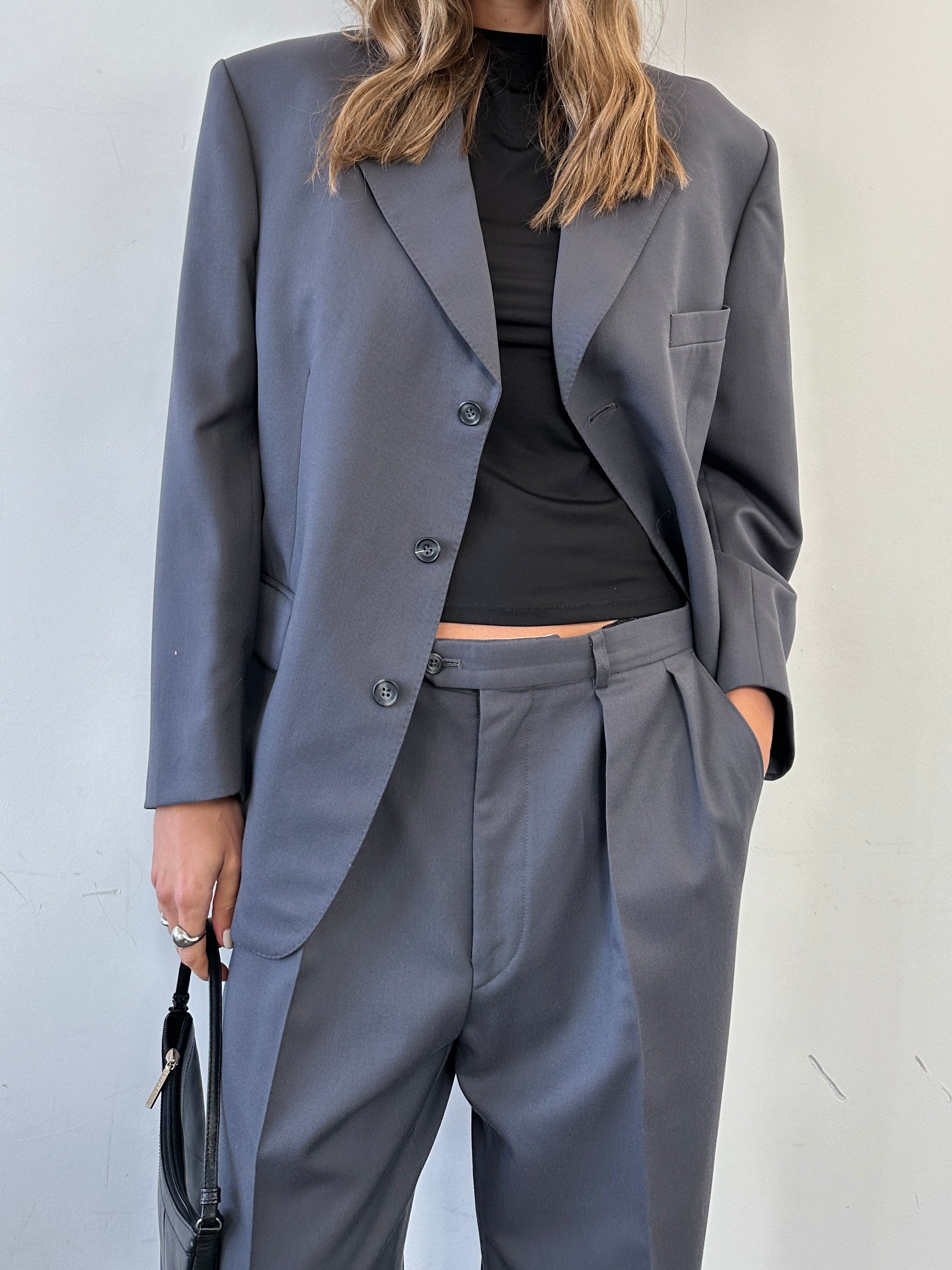 Christian Dior wool single-breasted jumpsuit in size 42S/W34, tailored fit, shown on model with lapel collar and waist pockets.