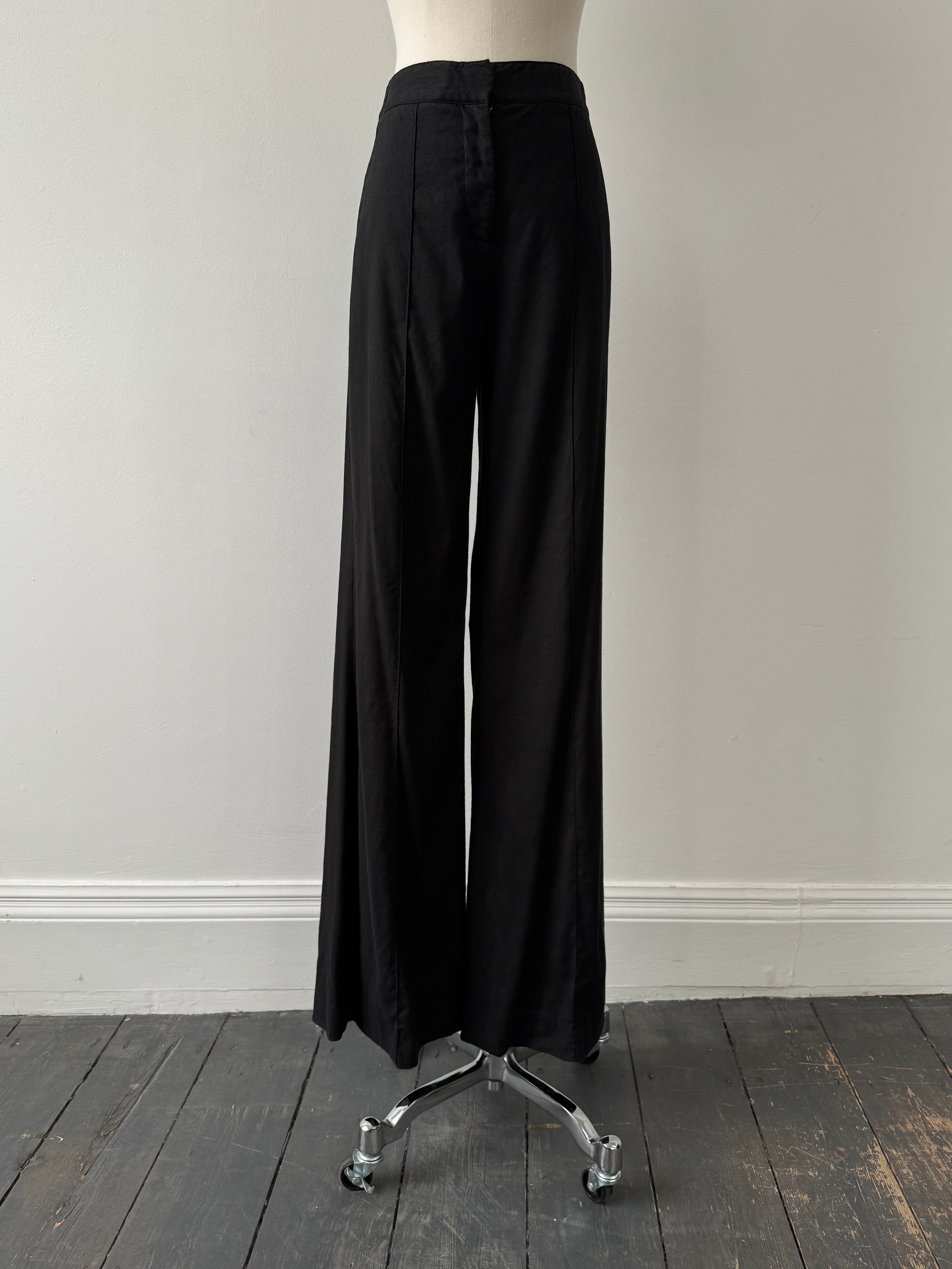 Diane Von Furstenberg 2000s linen wide-leg trousers in W24, beige color, high waist and relaxed fit, displayed on a hanger.