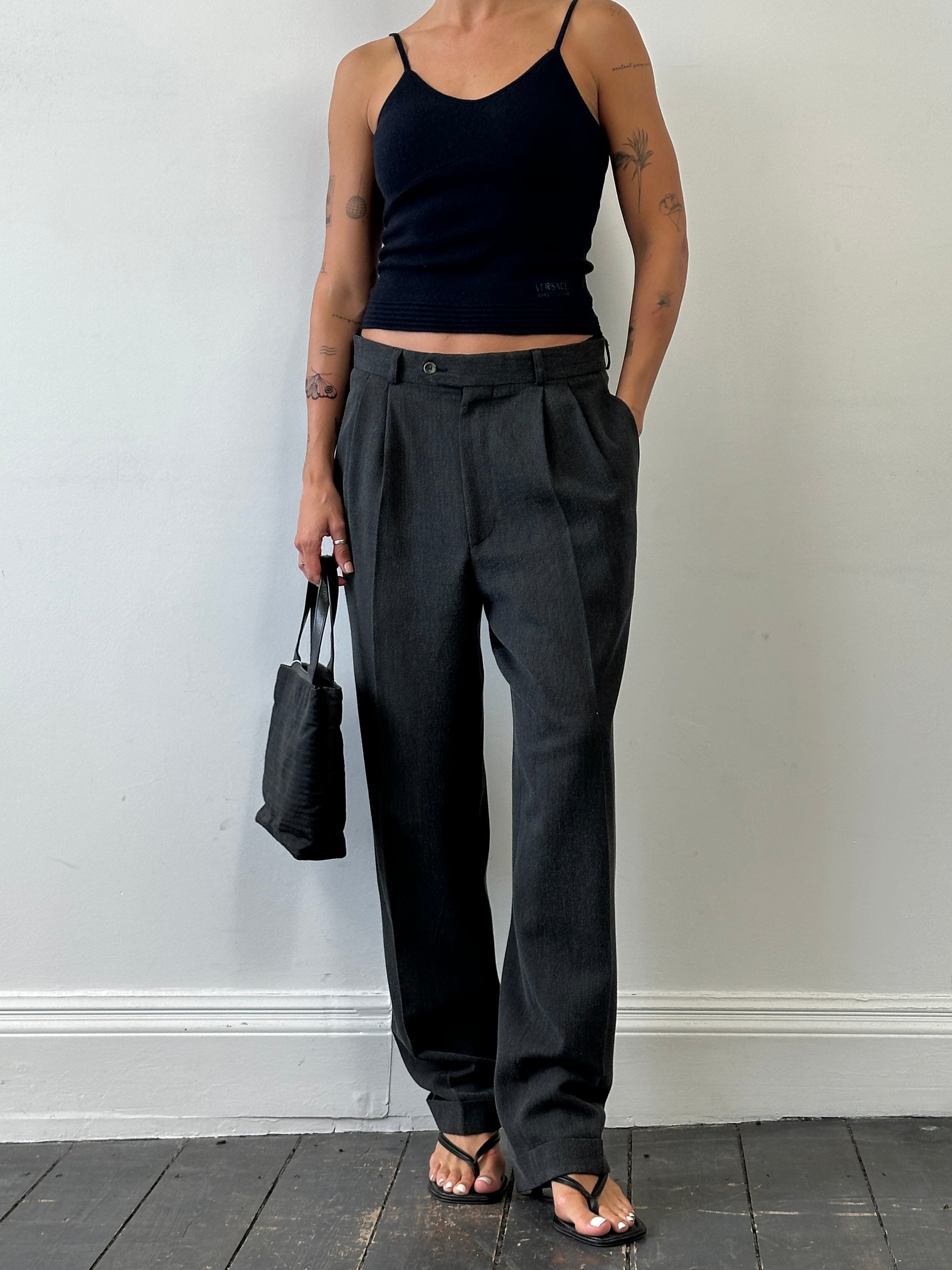 Vintage high waisted woven pleated tailored trousers in size W30, showcasing classic design and textured fabric.