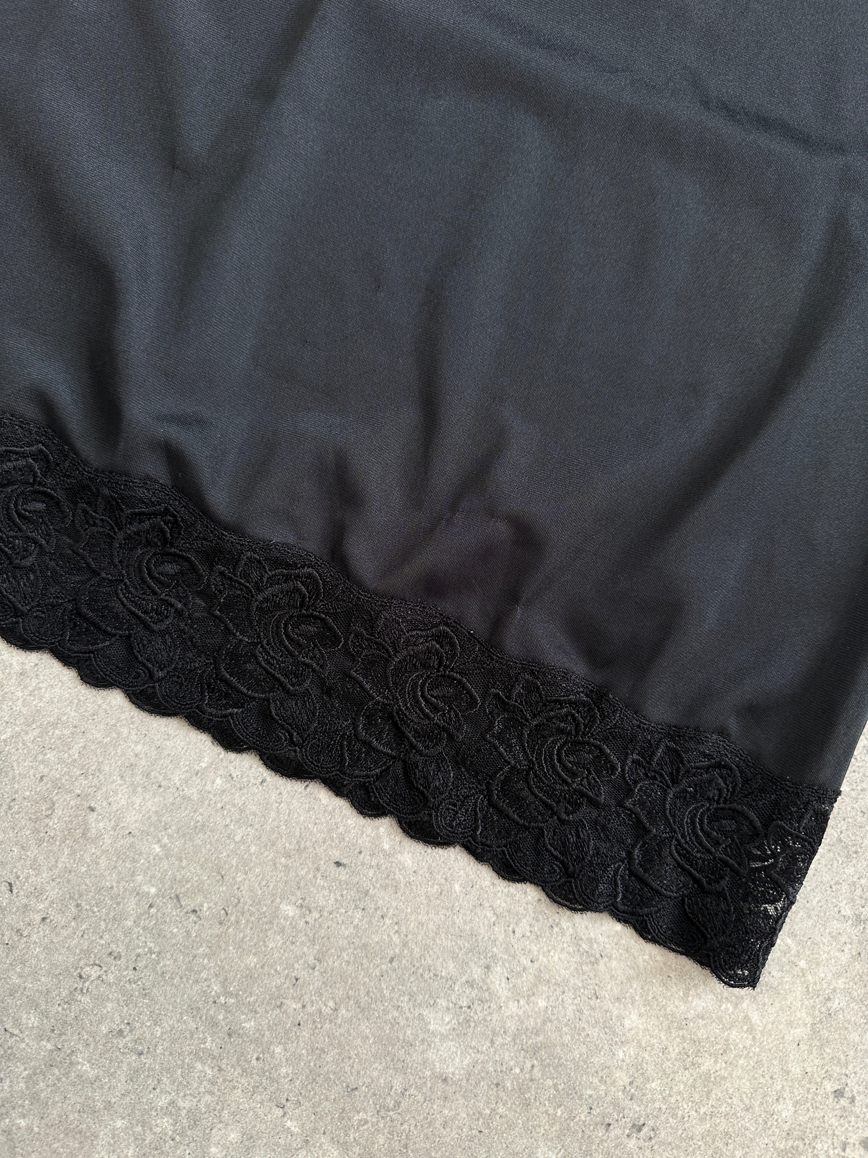 Vintage 1990s lace mini slip dress in black, featuring delicate lace details and a fitted silhouette, size S/M.