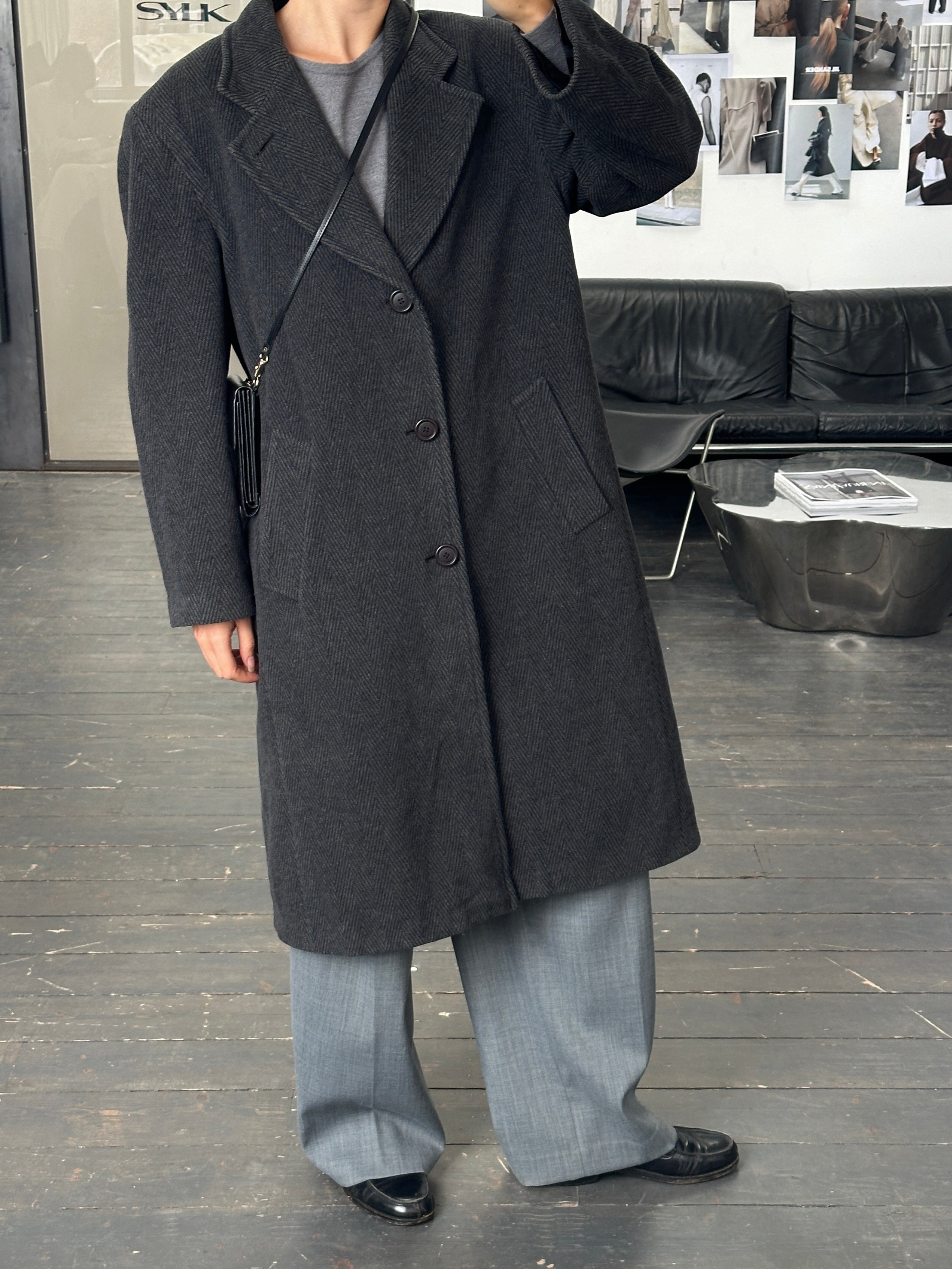 Italian vintage 1980s wool cashmere herringbone coat in XL, showcasing classic tailored design and textured fabric.