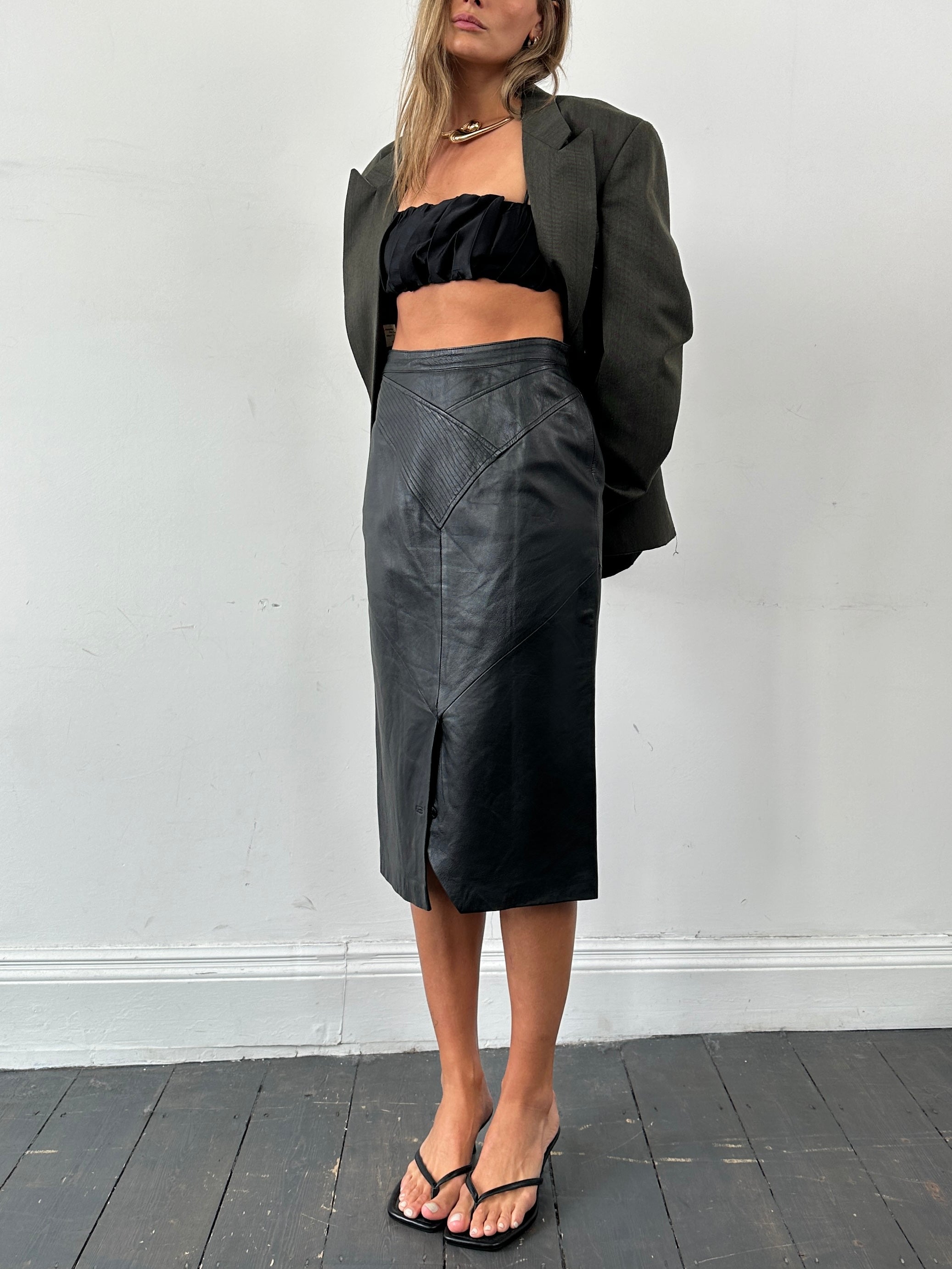 Vintage leather midi skirt in size W28, featuring a classic style and textured leather finish.