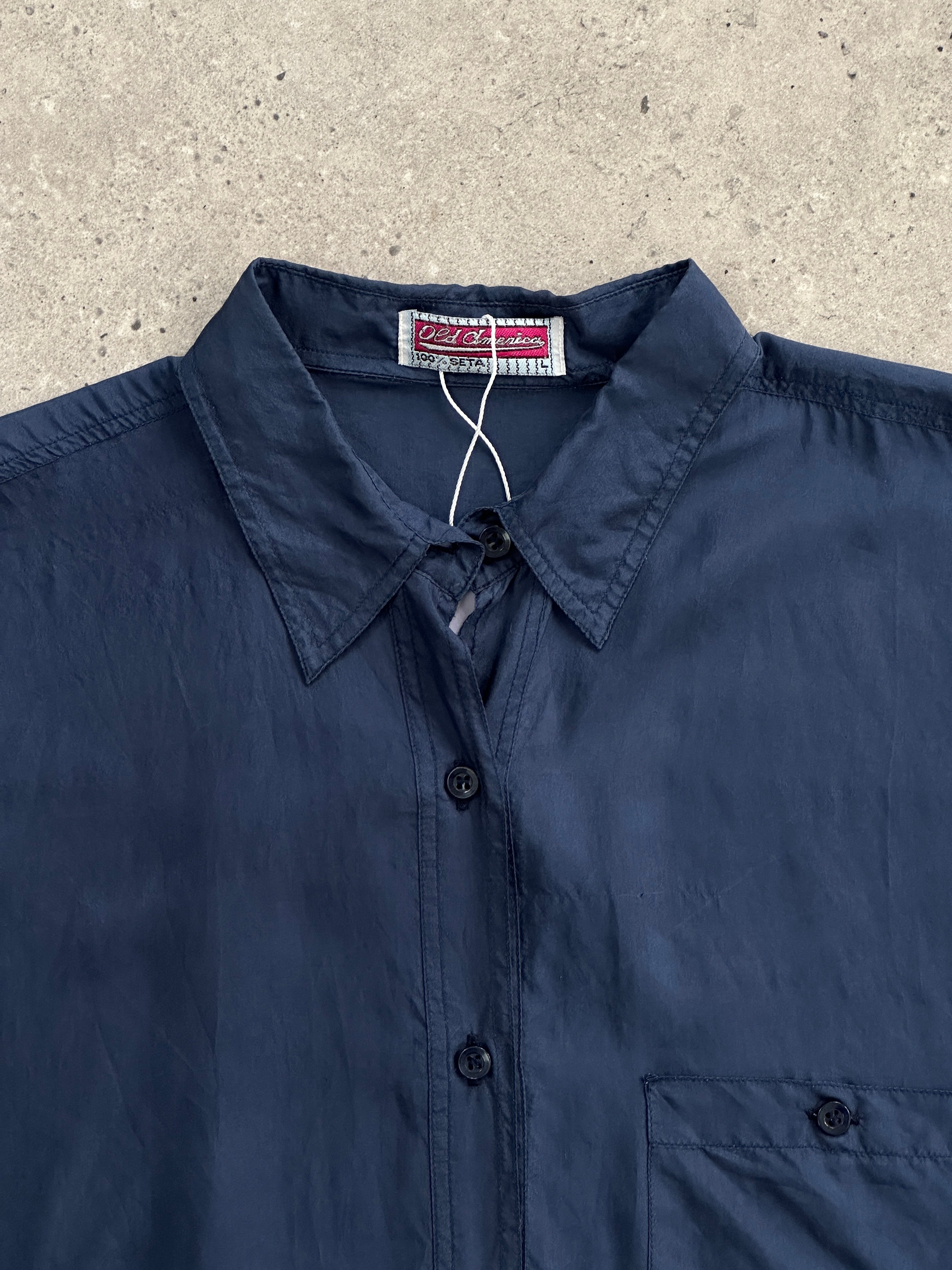 Vintage relaxed pure silk shirt in XL size, light and flowy with a classic collar and long sleeves, displayed on a hanger.