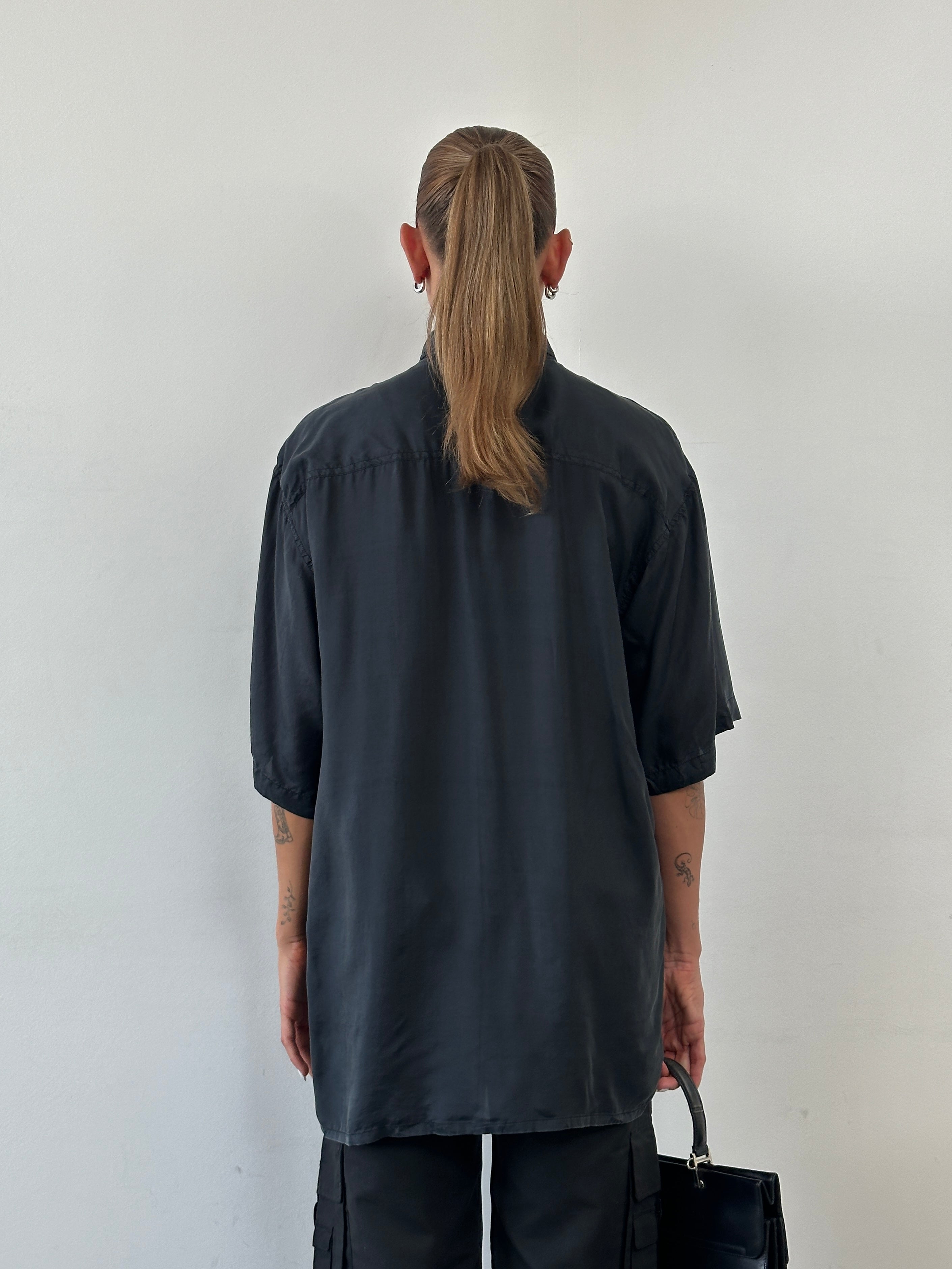 Vintage pure silk short sleeve shirt in size L/XL, with a classic collar and smooth fabric, displayed on a neutral background.