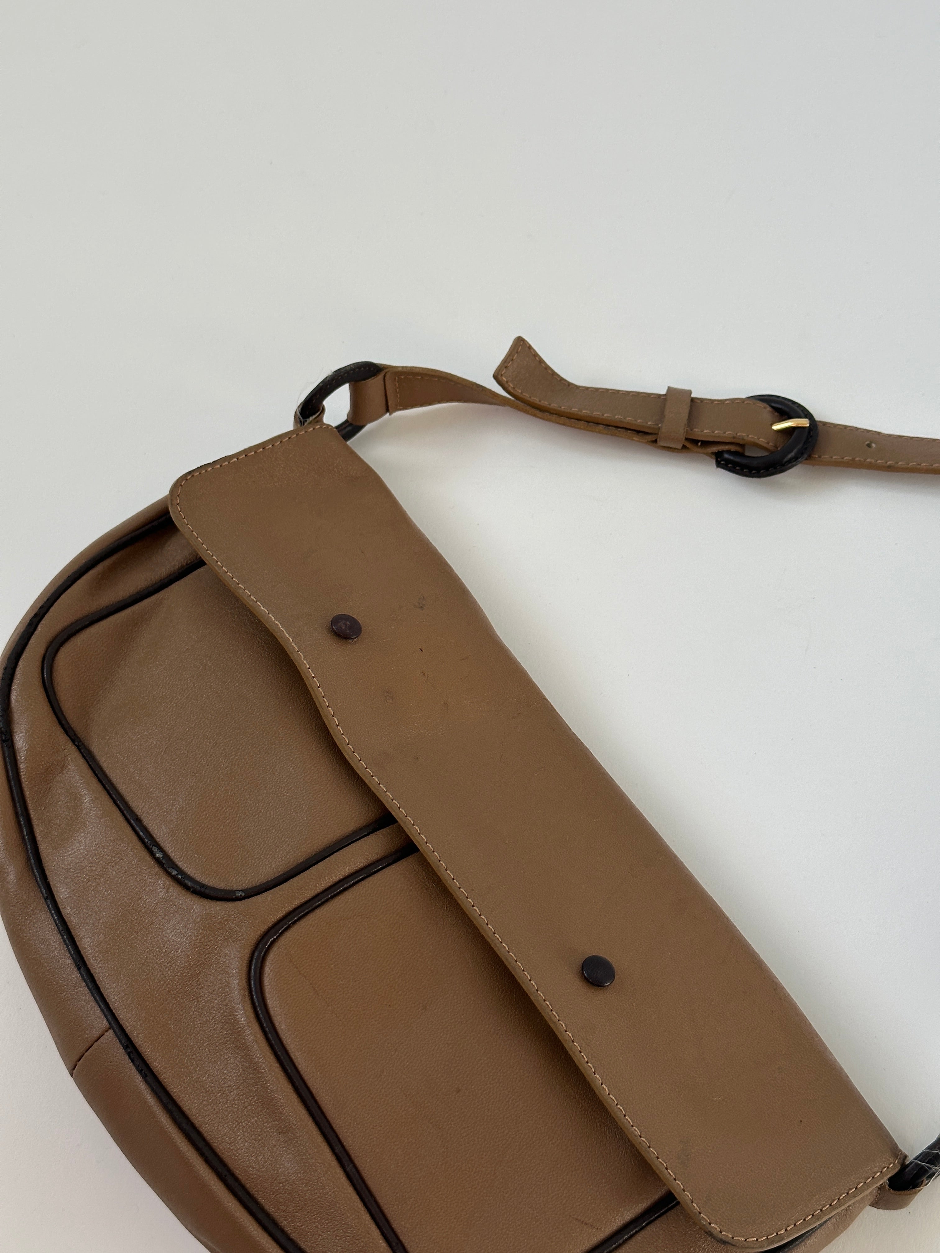 Vintage Italian leather crescent crossbody bag with antique finish and adjustable strap, stylish and functional accessory.