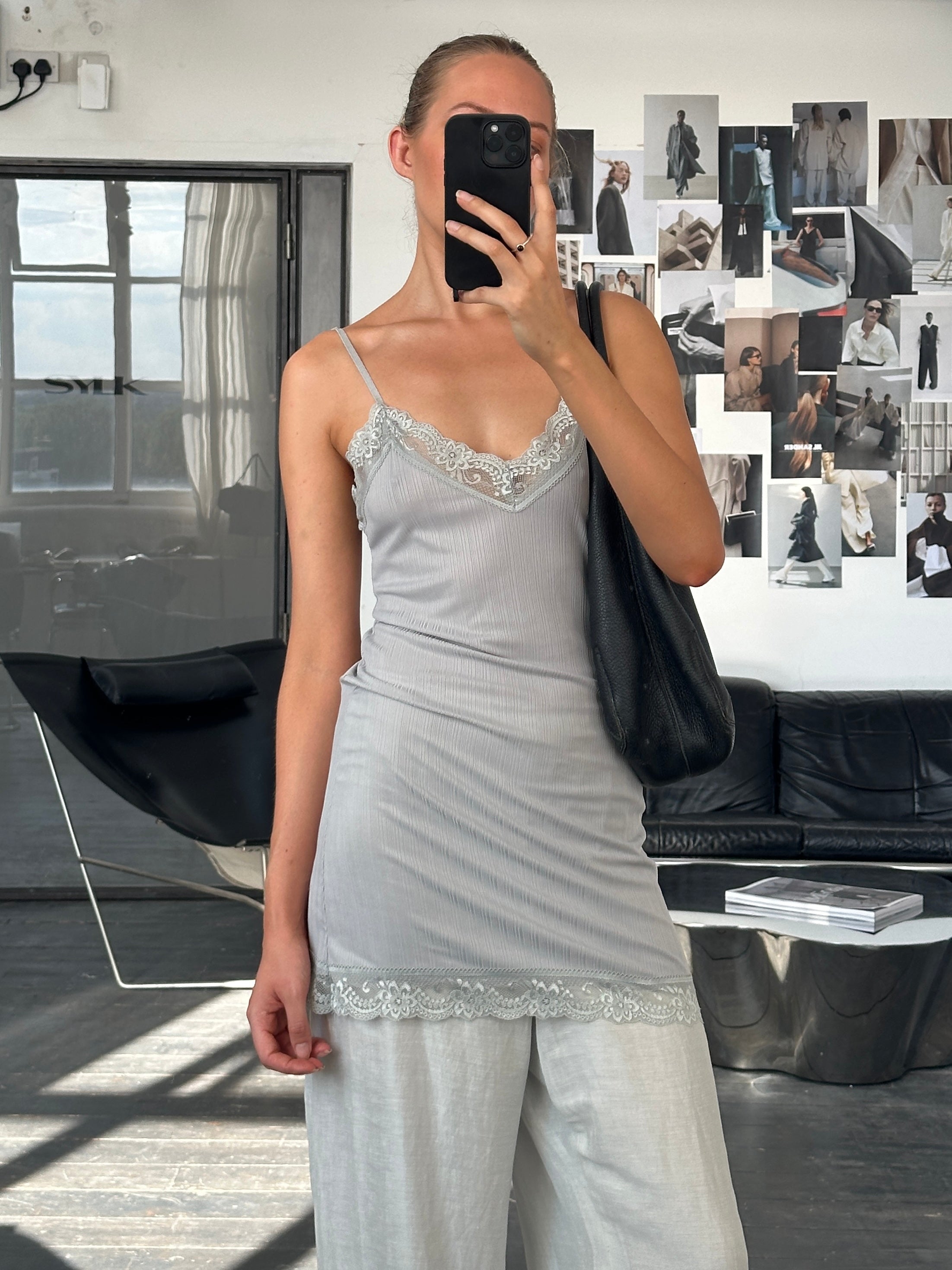 Vintage Italian 1990s lace sheer mini slip dress, size S, featuring delicate lace and lightweight fabric.