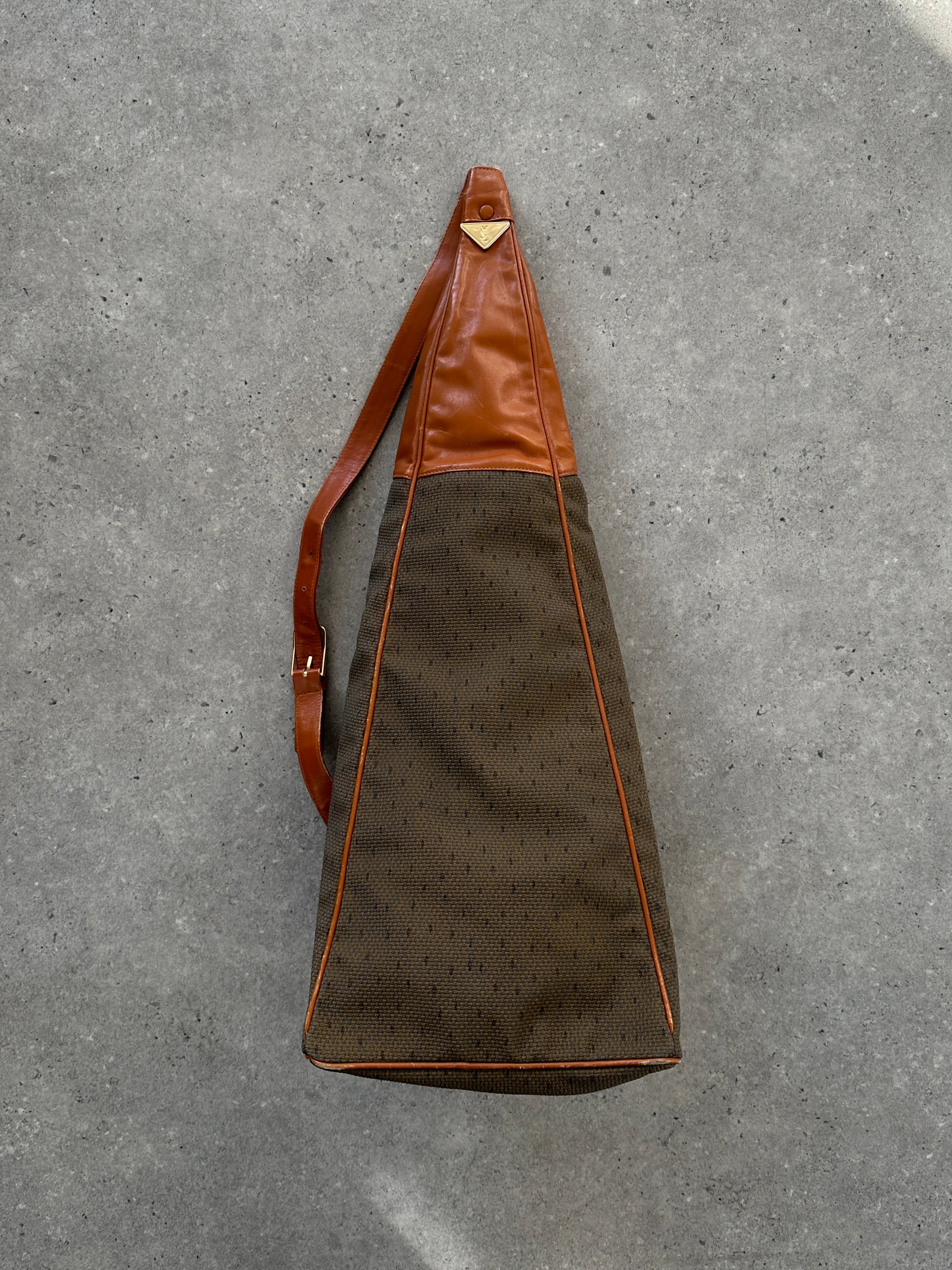 Yves Saint Laurent Paris 80s leather sling bag with sleek design, featuring a compact structure and elegant black leather finish.