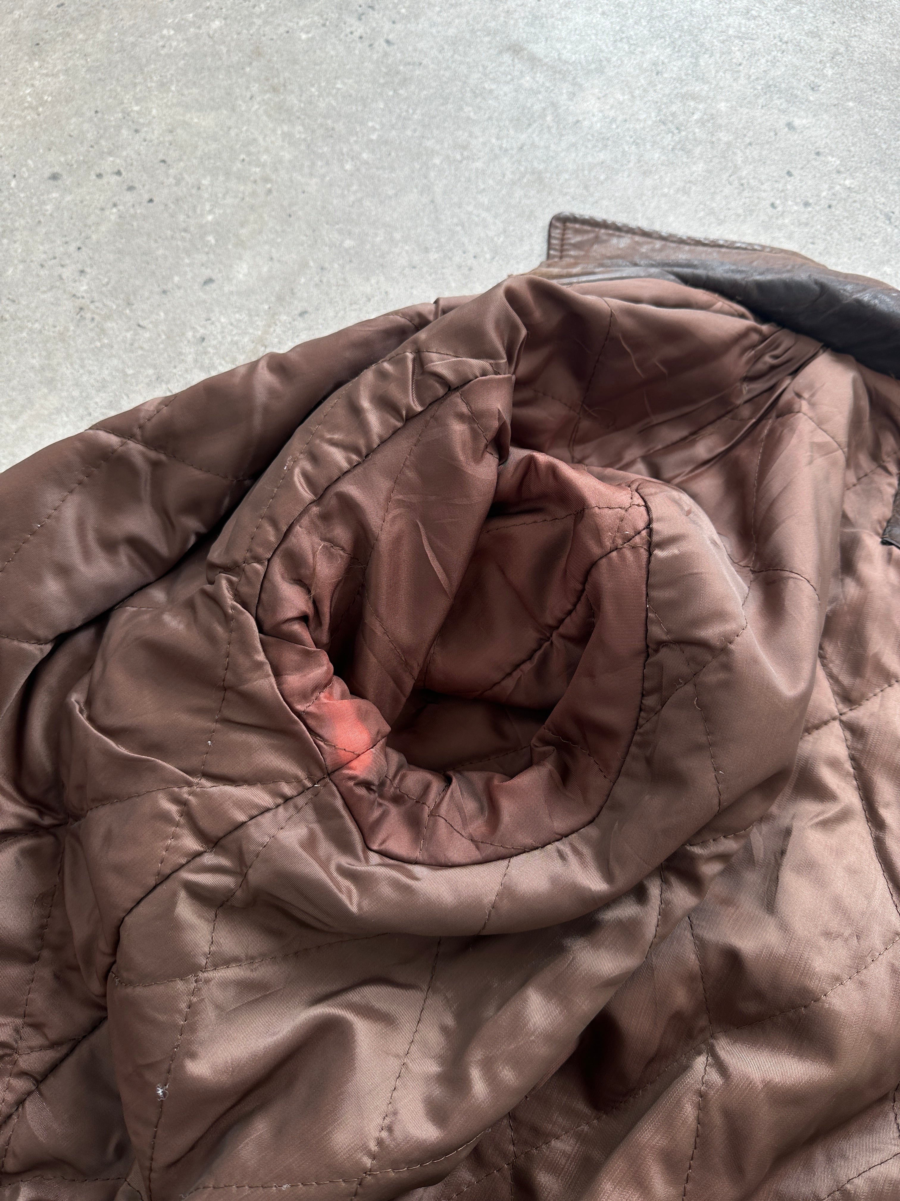 Vintage distressed leather bomber jacket in size L, featuring a rugged, worn-in look with classic design elements.