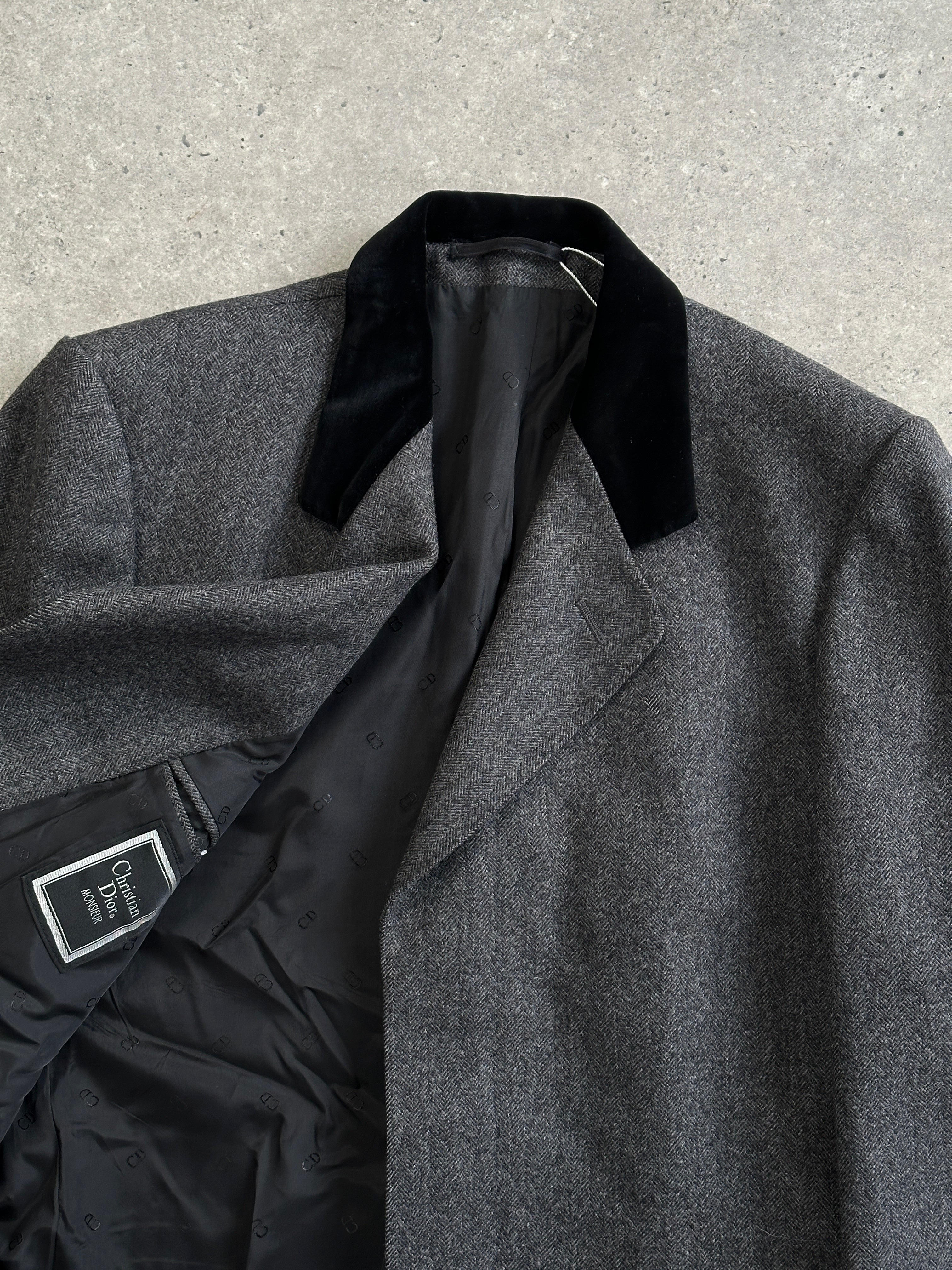 Christian Dior pure wool single-breasted coat in size L/XL, shown on a hanger with a classic tailored design.