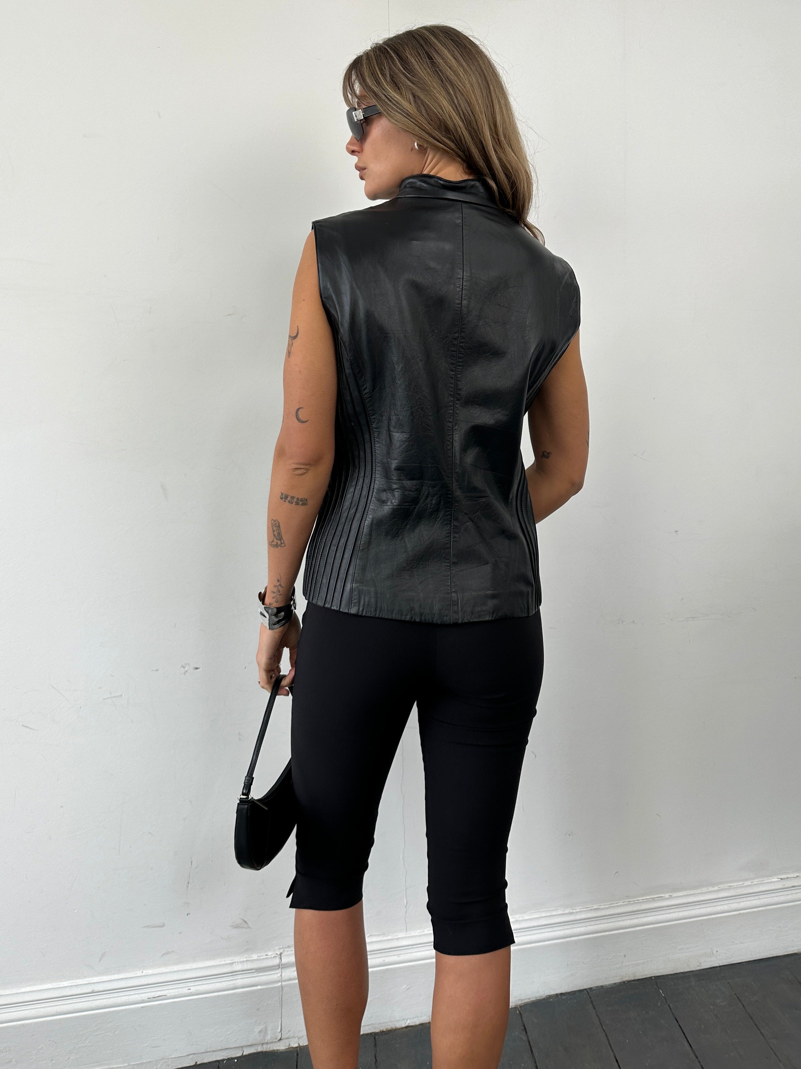 Vintage leather double zip pleated vest jacket, size L, featuring a stylish design and multiple zipper closures.