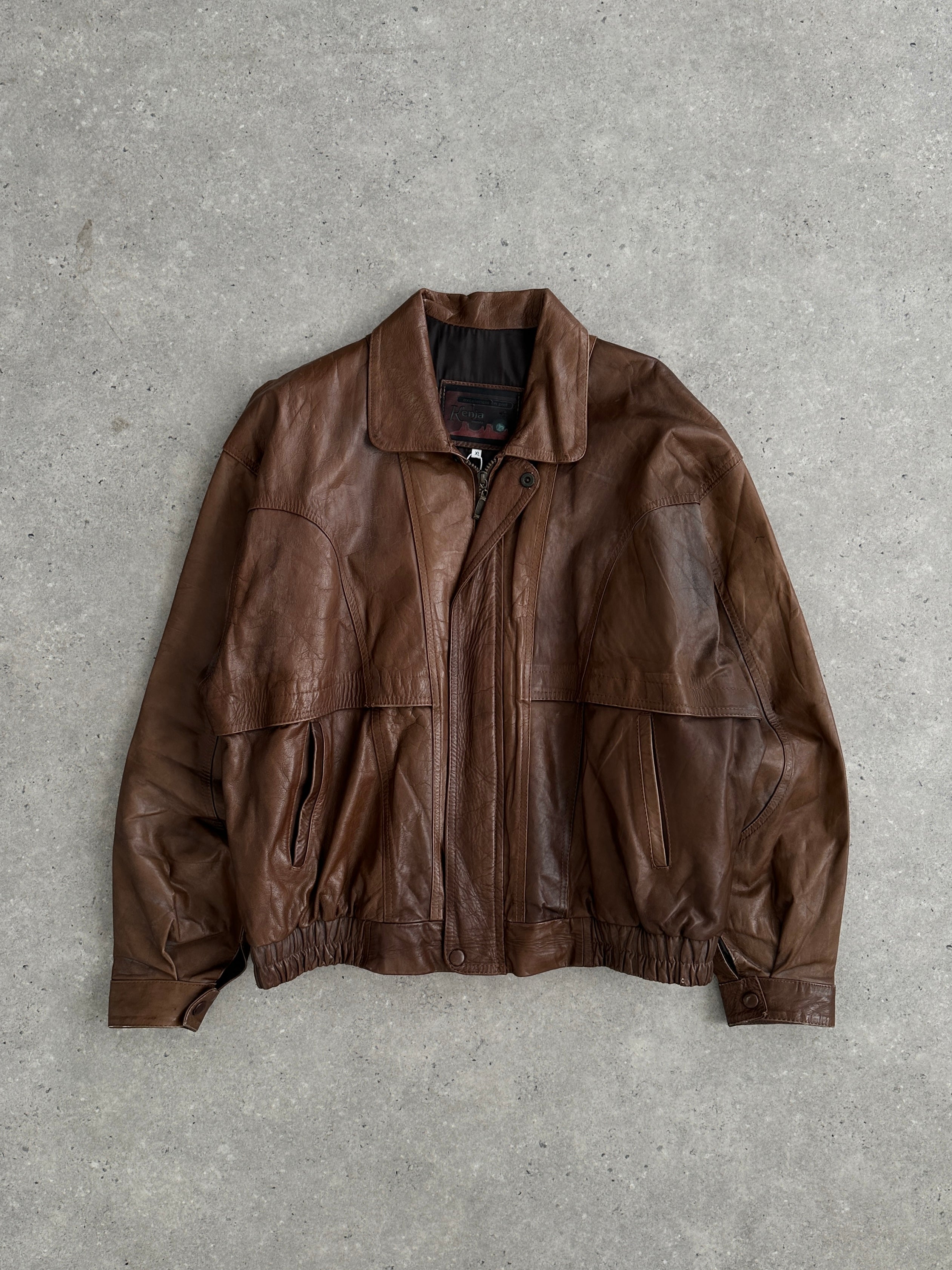 Vintage tobacco leather bomber jacket in XL size, featuring a classic design with ribbed cuffs and collar, stylish and durable.
