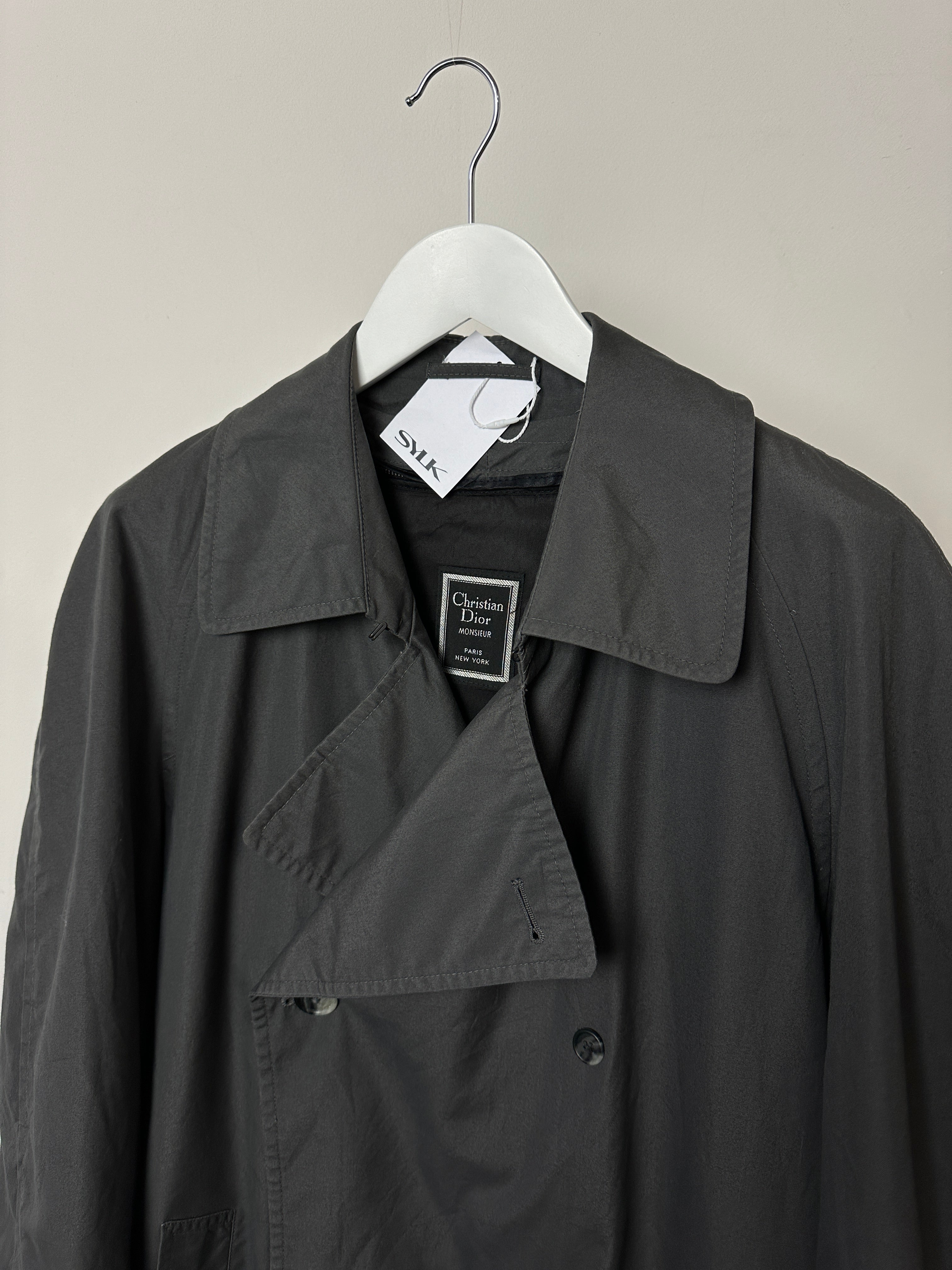 Christian Dior double-breasted trench coat in size L, featuring classic design and tailored silhouette, shown in the image.