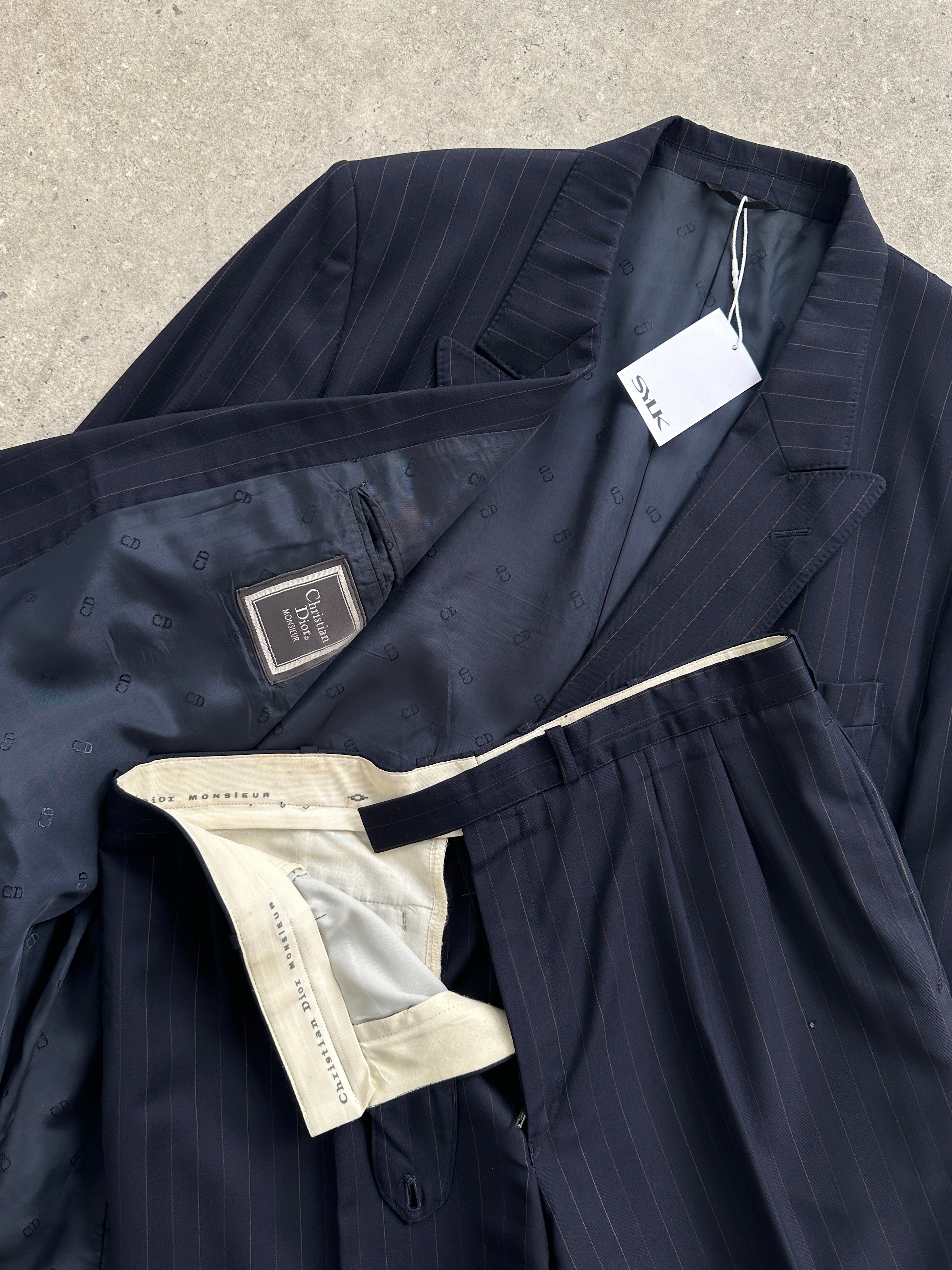 Christian Dior pinstripe wool jumpsuit with double-breasted front and tailored fit, size 44R/W34, showcasing elegant design and craftsmanship.
