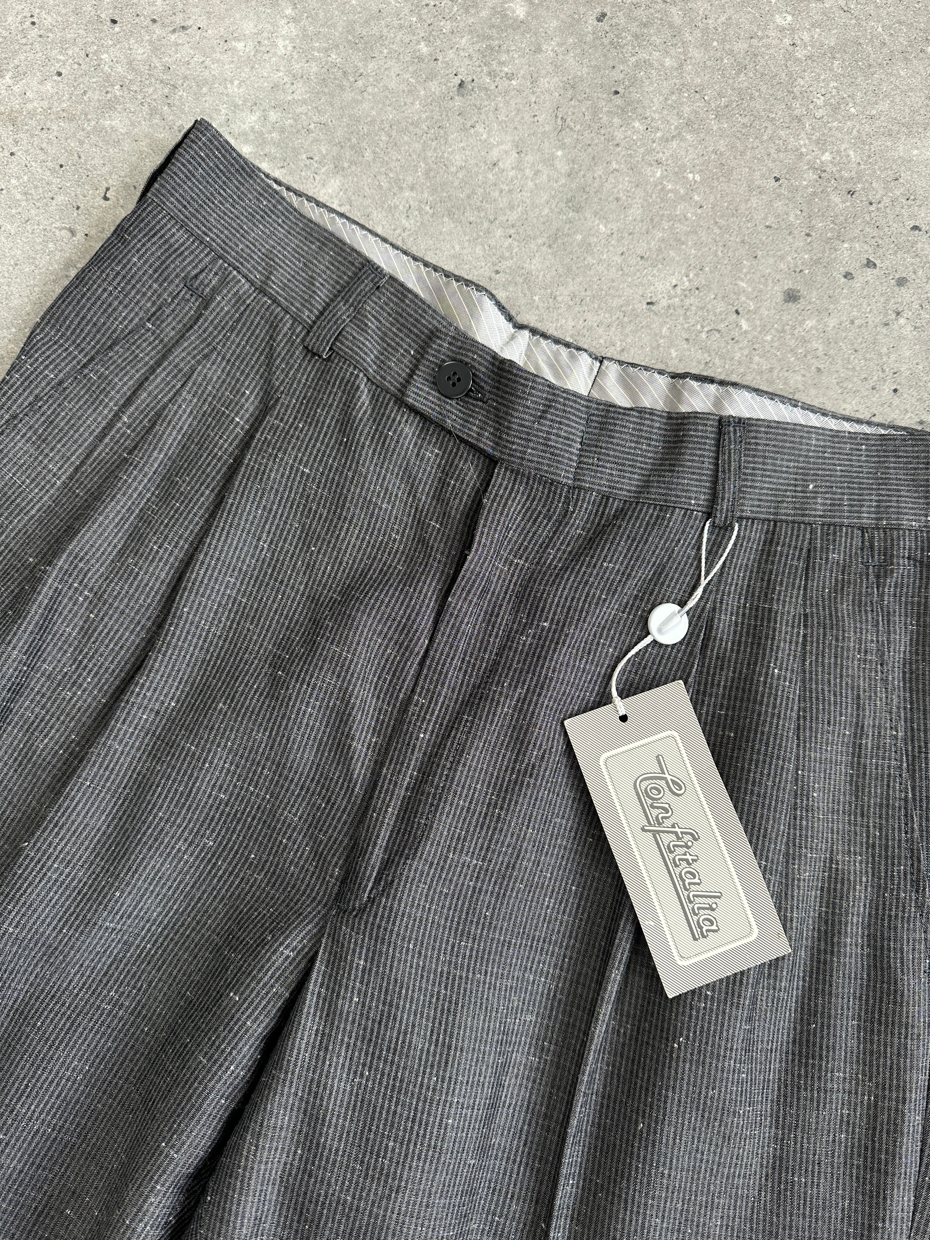 Vintage Italian high-waisted tailored trousers with raw hem and straight leg, size W28, showcasing classic vintage style.