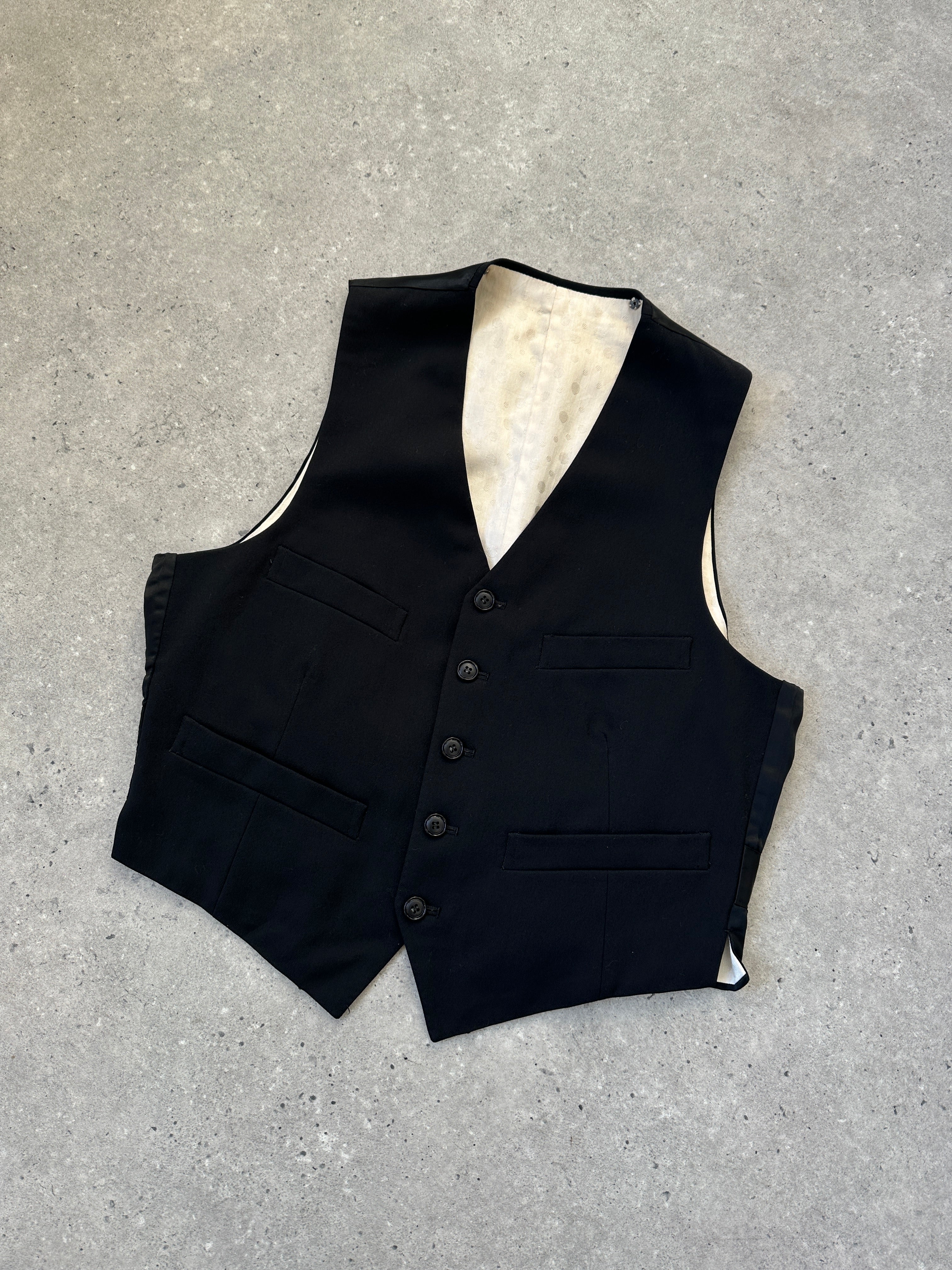 Vintage brand vintage tuxedo wool waistcoat, a classic men's coat with tailored fit and button details in a rich wool fabric.