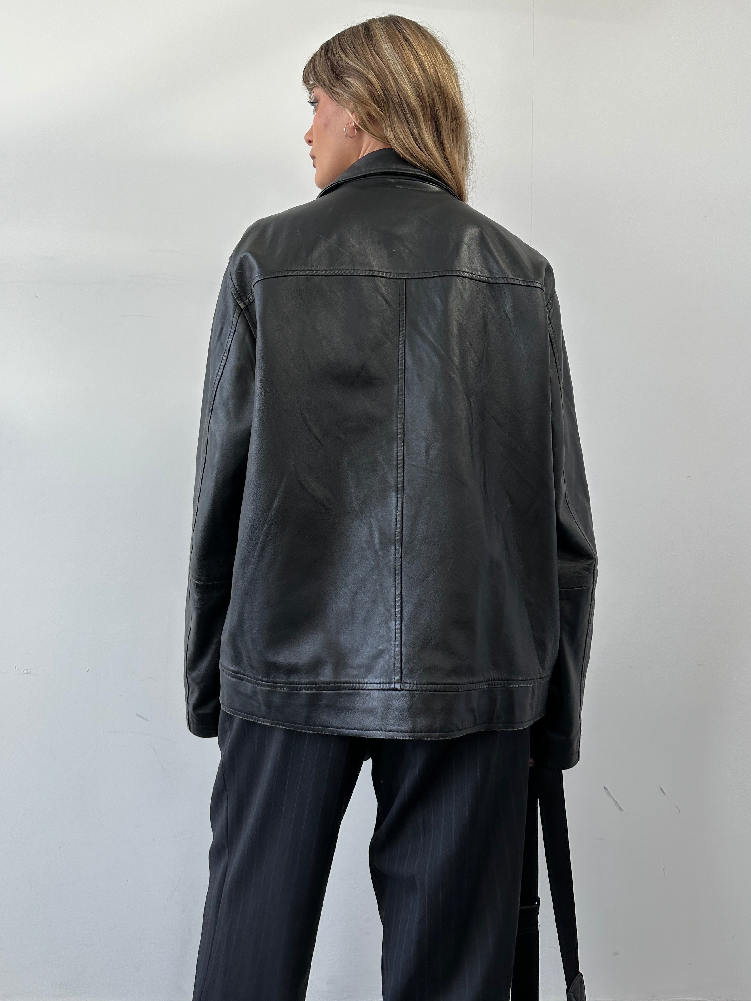 Conbipel minimal leather jacket in size L, featuring sleek design and smooth leather material, displayed on a hanger.