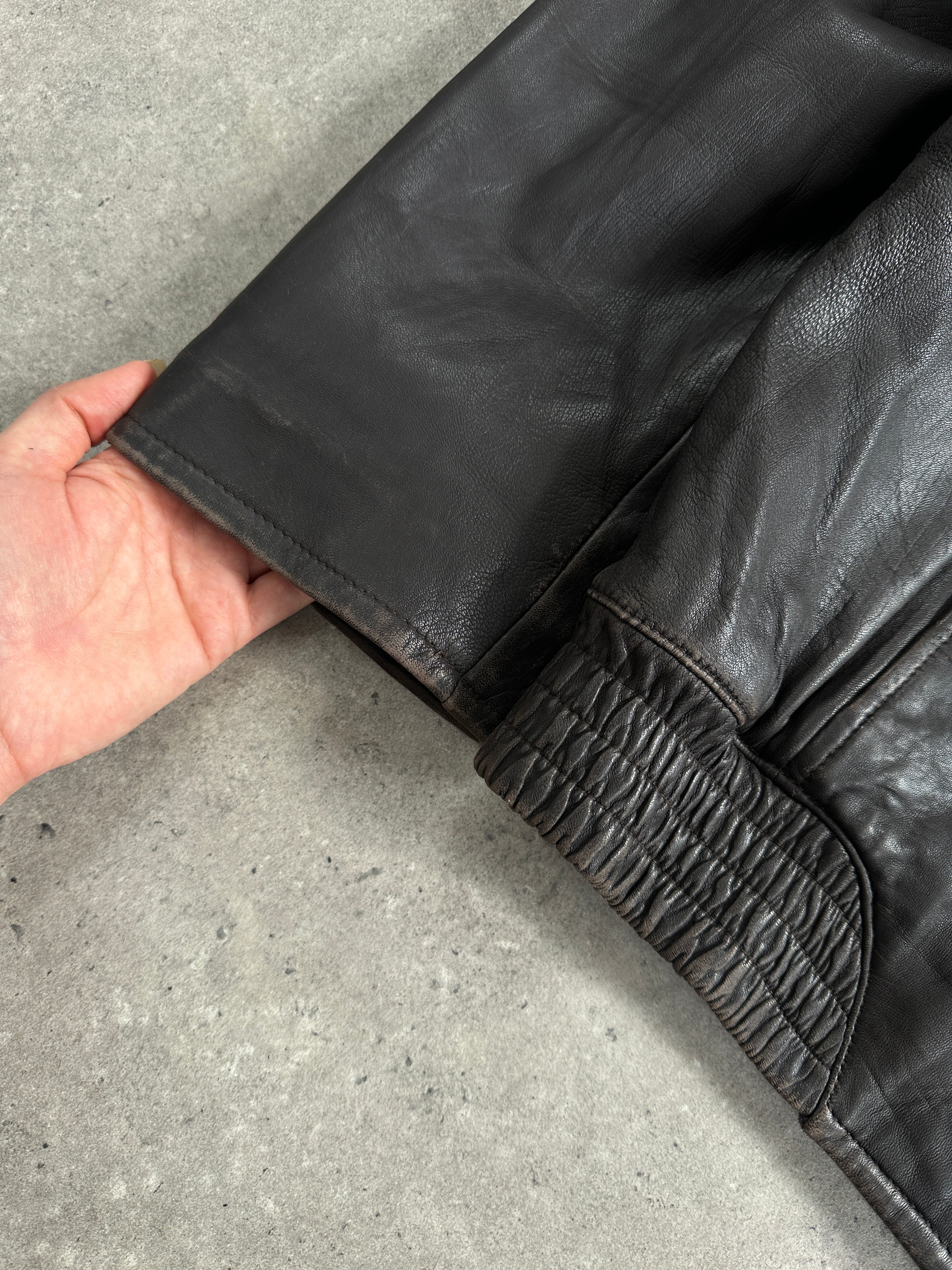 London Fog 1990s distressed leather jacket in size L, close-up of textured, vintage-style brown leather with distressed finish.