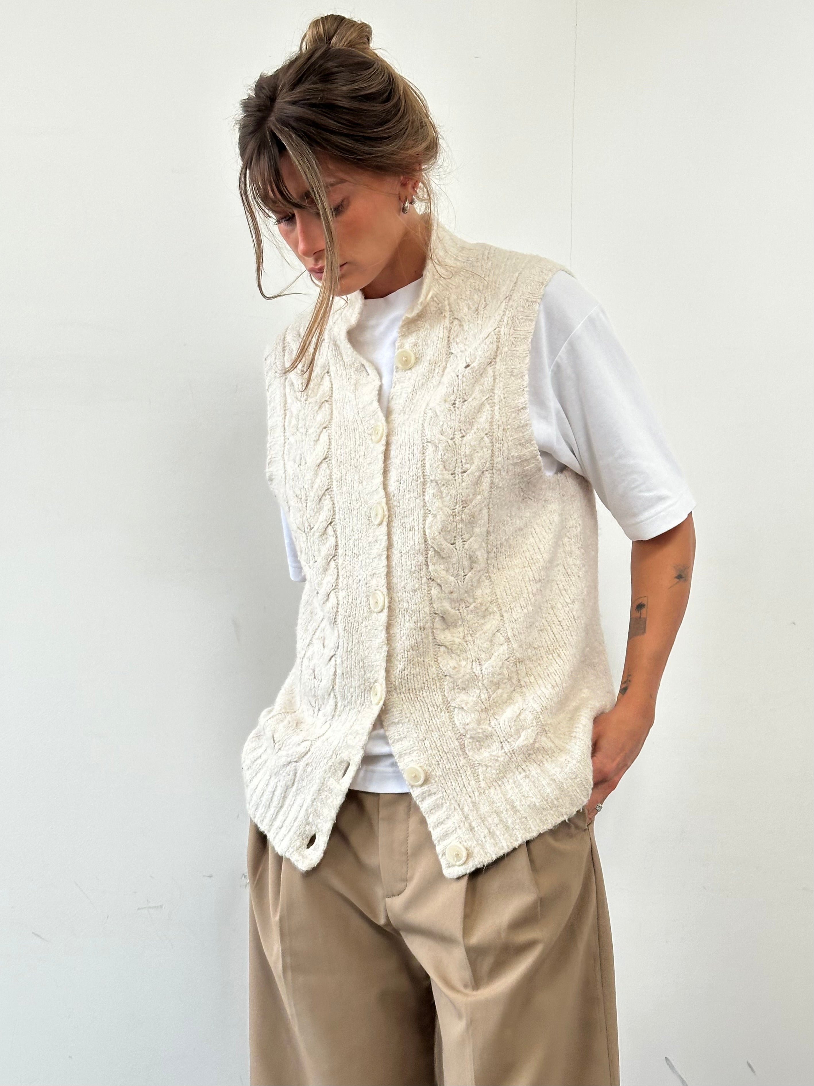L.L. Bean wool sleeveless knitted cardigan in size L, featuring a cozy, textured design and button closure.