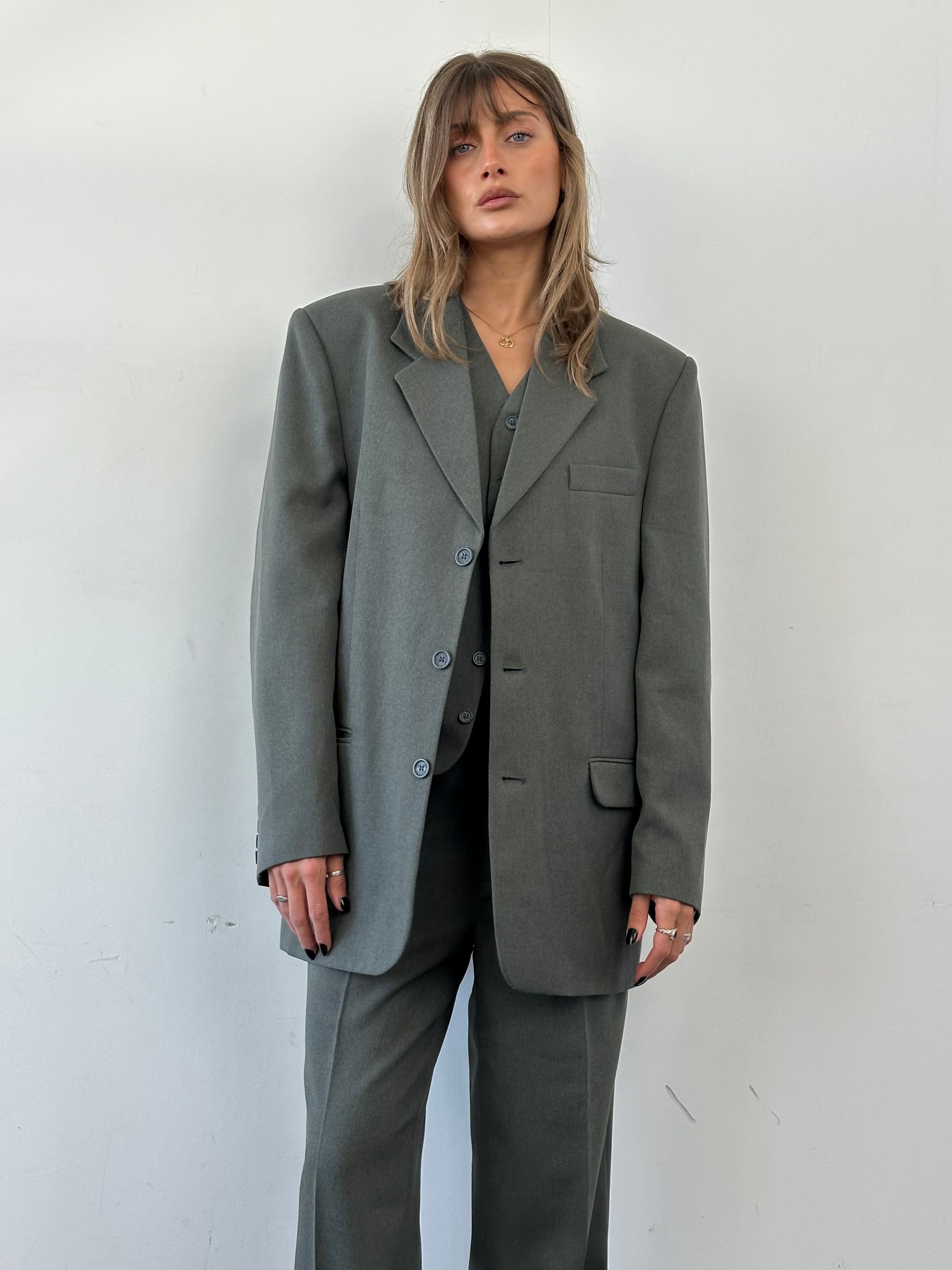 Vintage three-piece suit in size 44R/W32, featuring classic tailored design, with jacket, vest, and trousers visible in the image.
