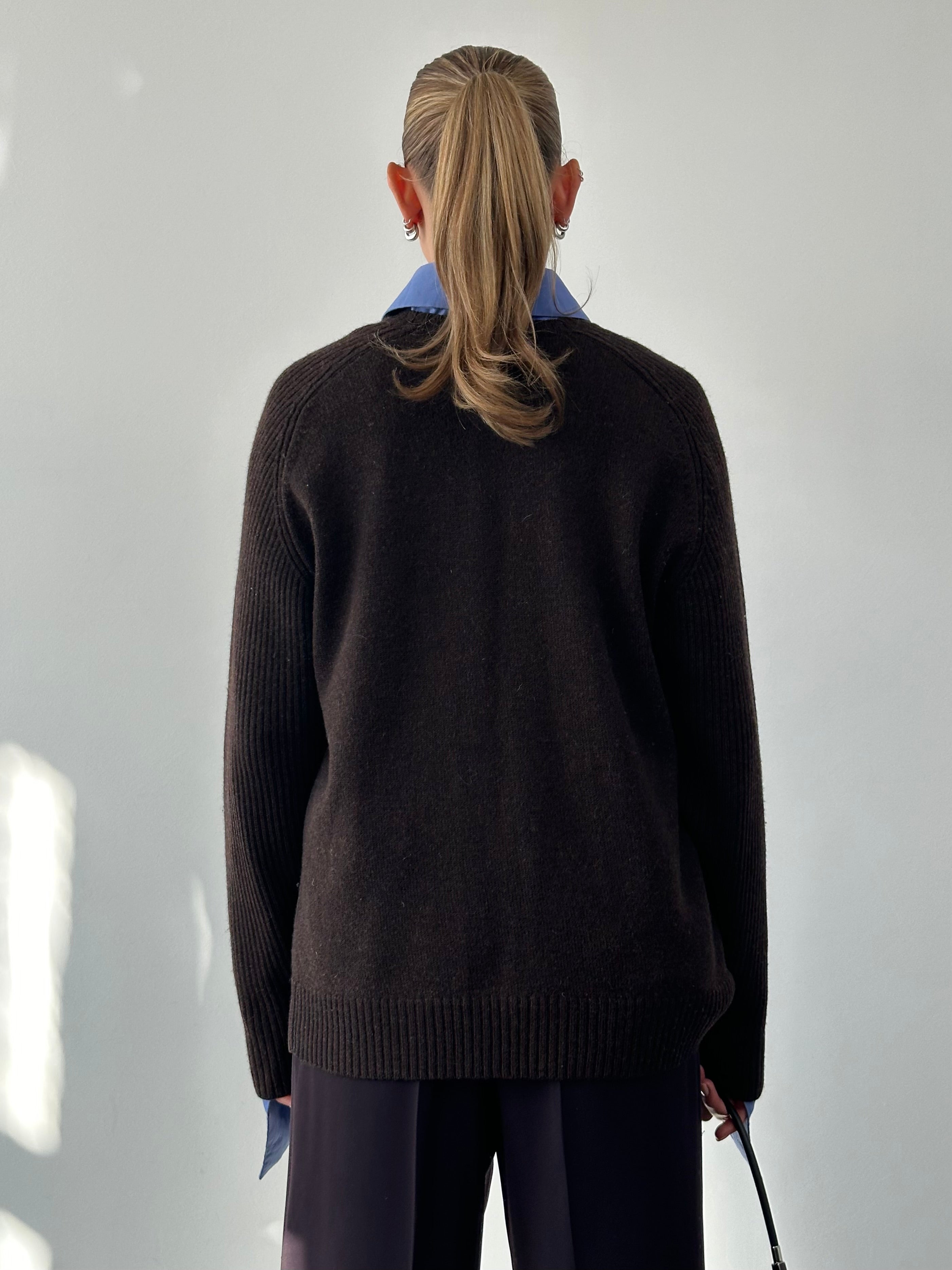 Jaeger pure merino wool jumper in size L/XL, soft and warm, shown on a hanger with a neutral background