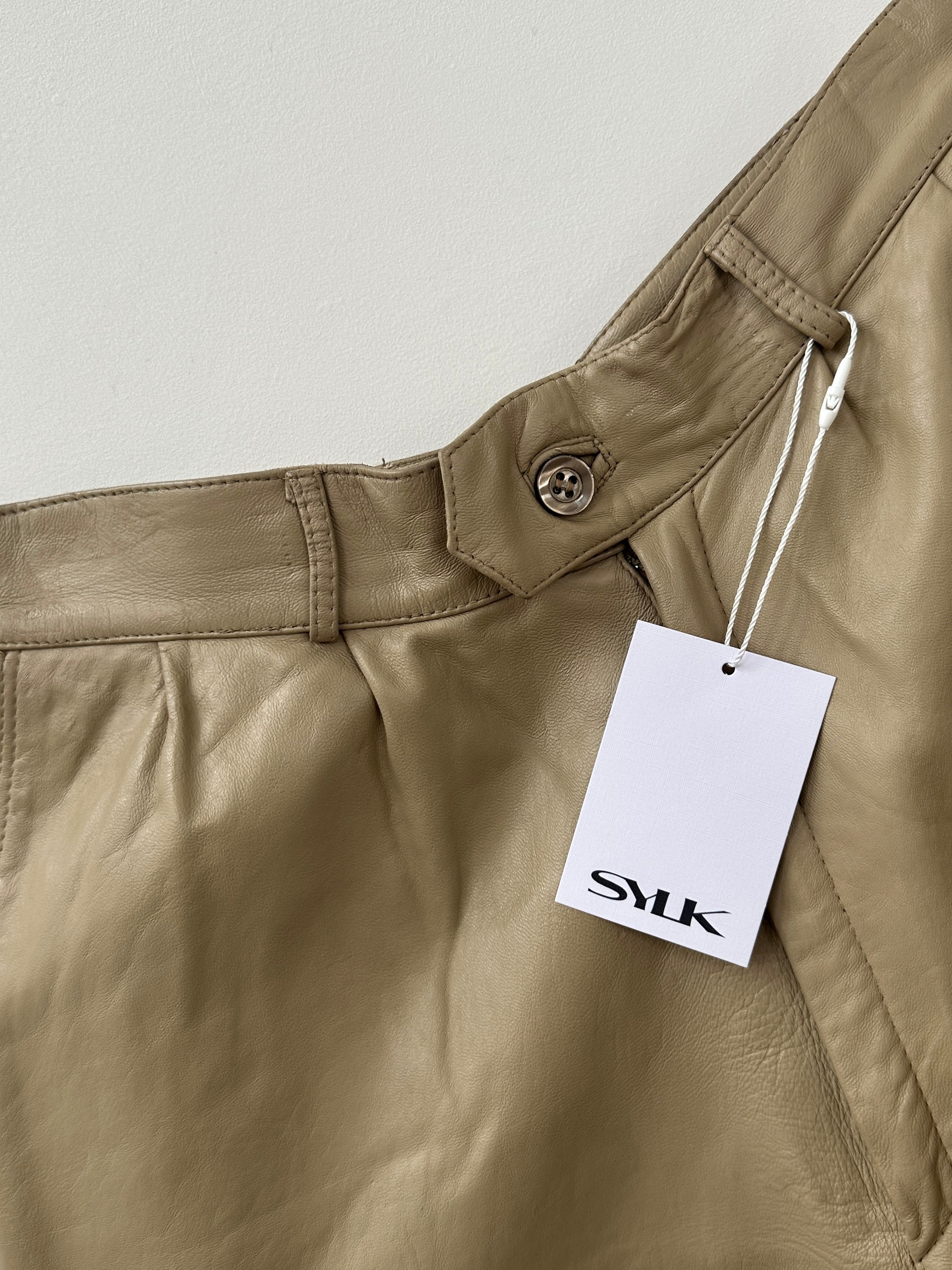 Vintage leather wide leg high-waisted long shorts, W24, shown in a natural stance with detailed leather texture and wide leg design.