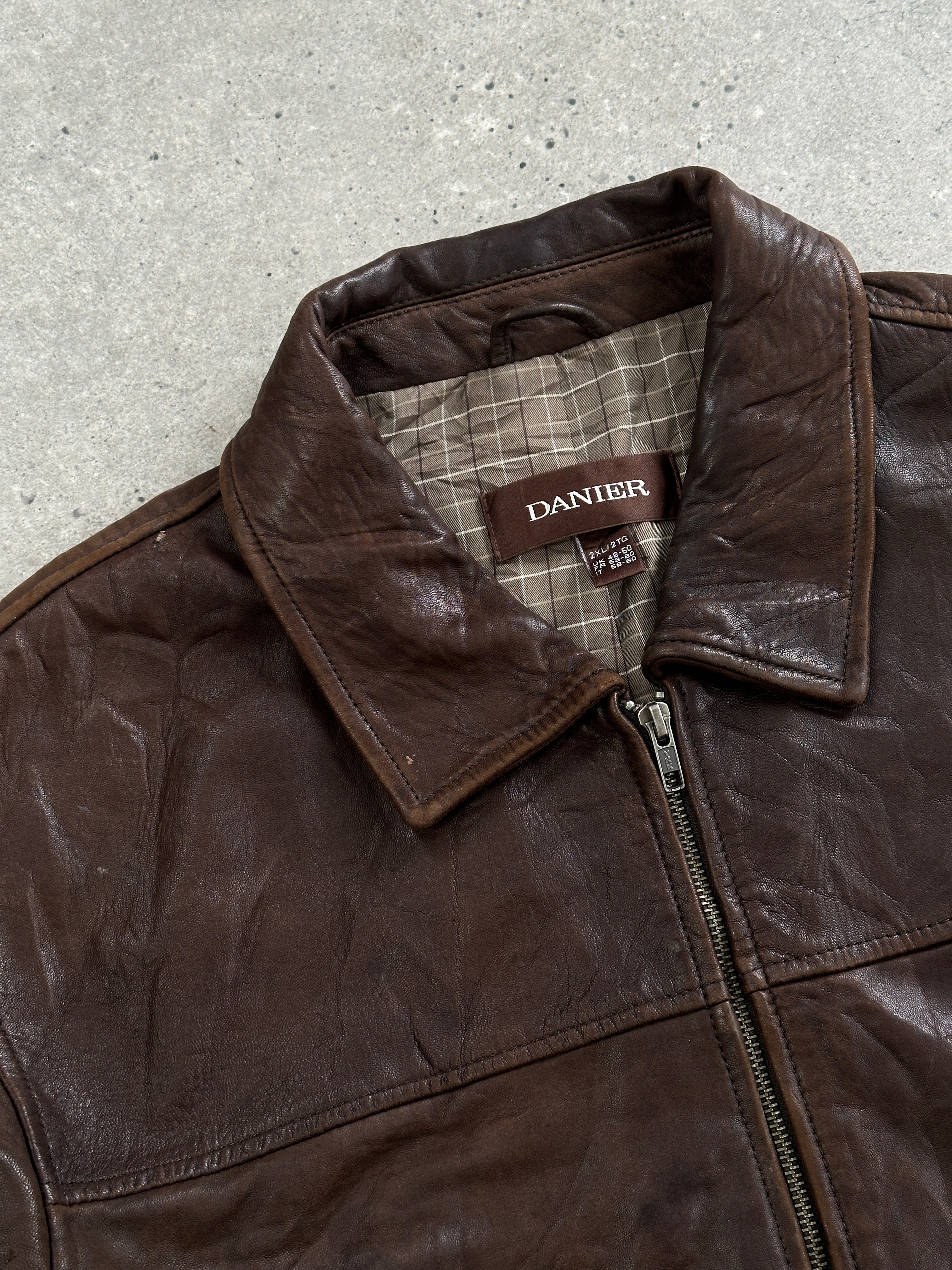 Vintage 1990s distressed leather jacket in XXL size with rugged texture and classic design, featuring worn leather and vintage style details.
