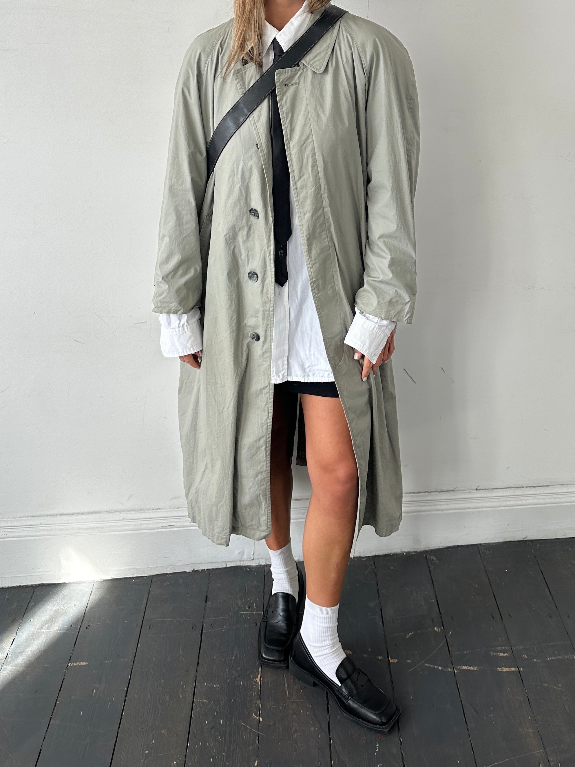 Christian Dior Le Connaisseur belted trench coat in size M, featuring classic design and stylish detailing, displayed on a model.