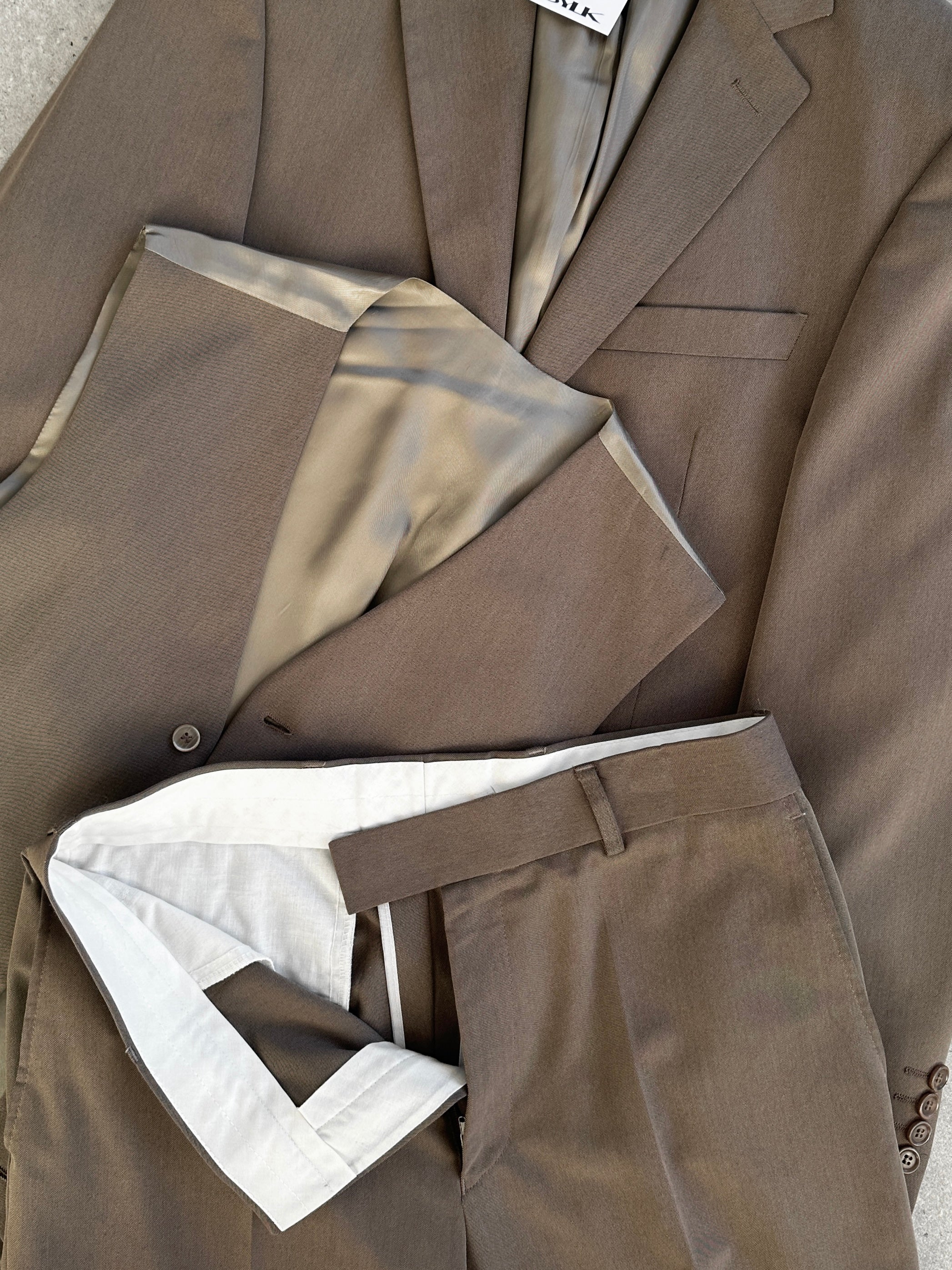 Vintage single-breasted three-piece suit in size 36R, featuring a classic design with jacket, vest, and trousers.
