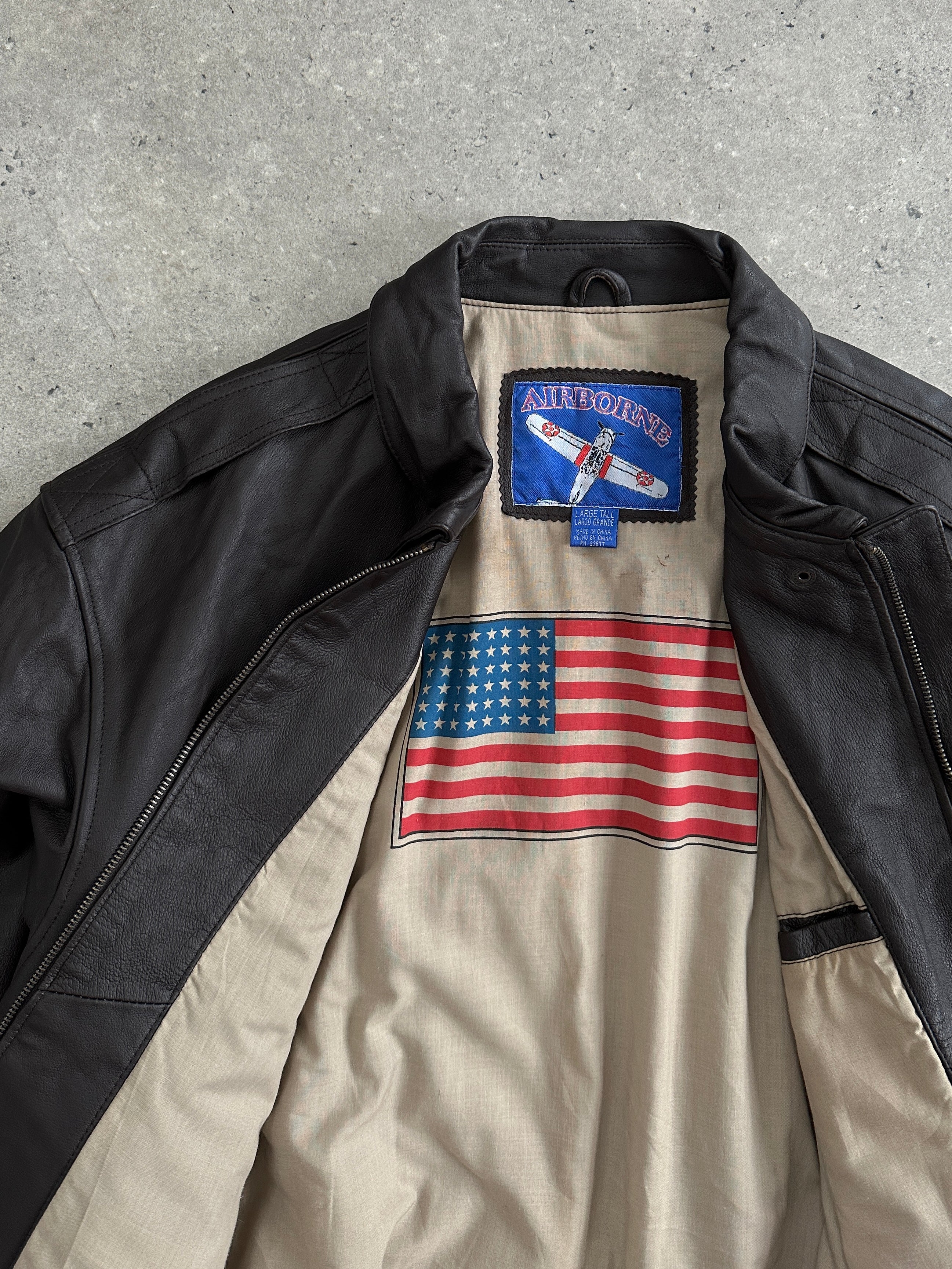 Vintage leather bomber jacket in XL size, featuring classic design with a rugged leather texture and a front zipper closure.