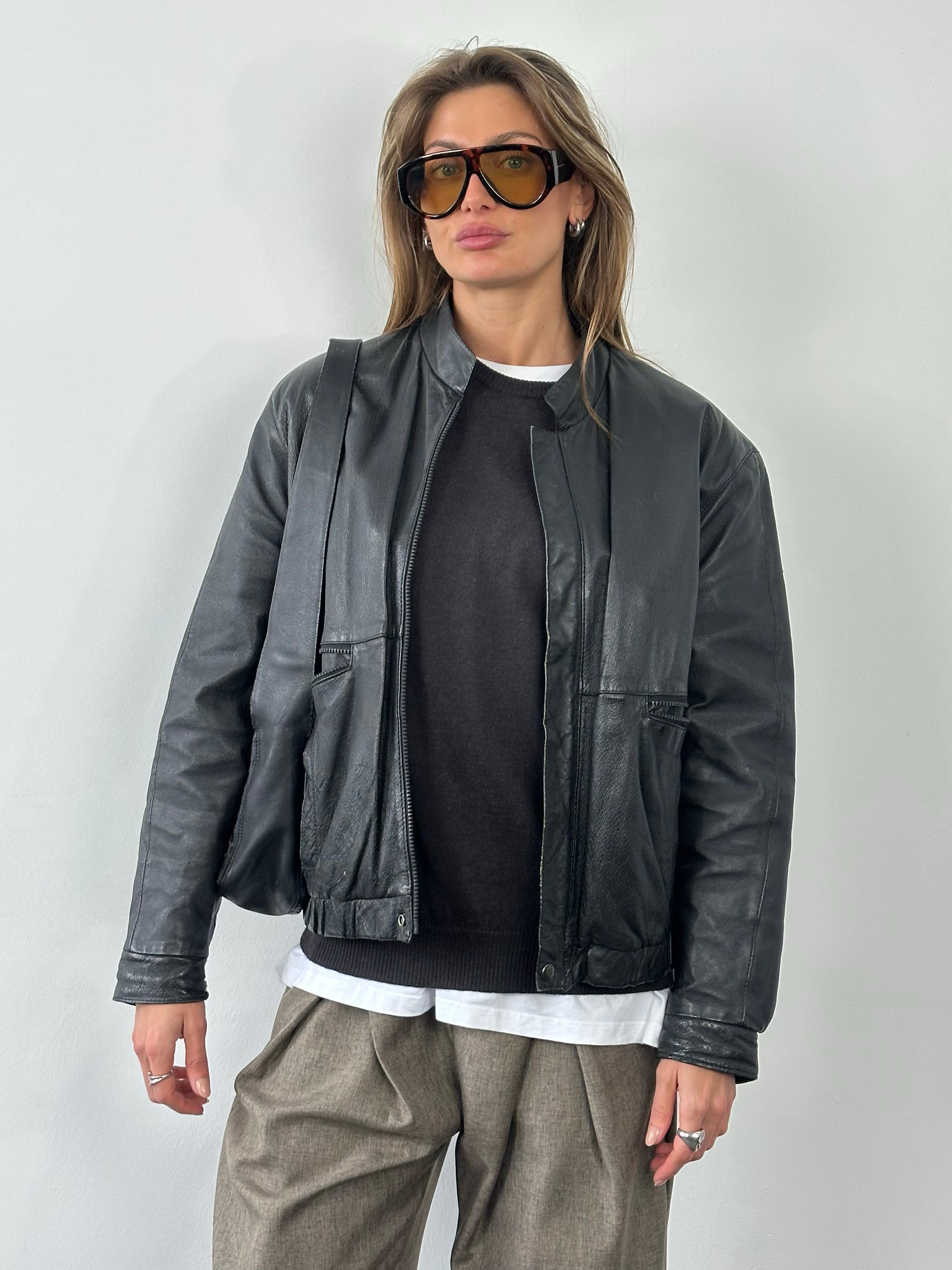 Vintage 1990s minimal leather jacket in size M, featuring sleek design and classic black leather from the Vintage brand.