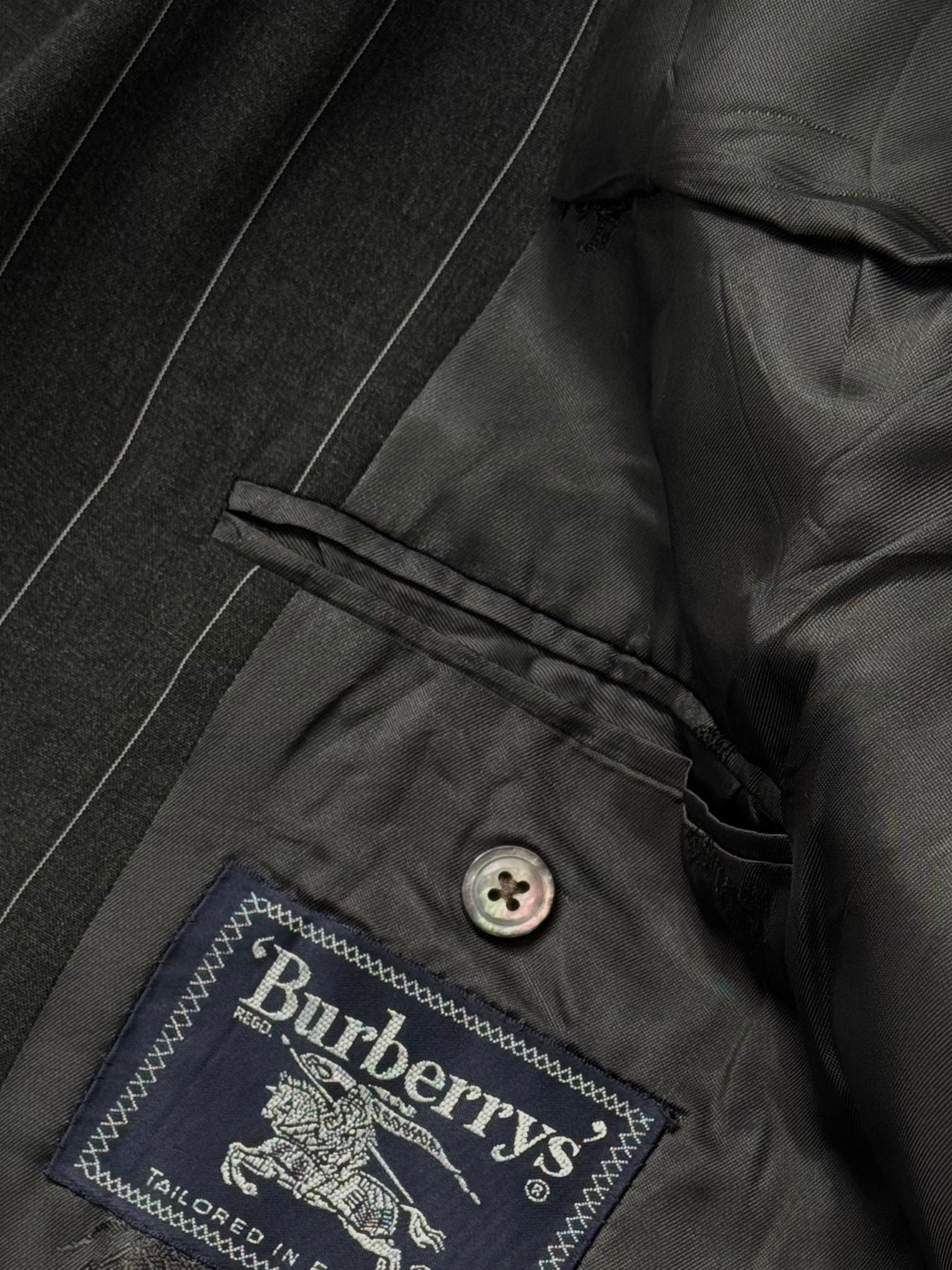 Burberry 1990s XL wool double-breasted stripe blazer, showcasing classic tailored design with bold stripe pattern.