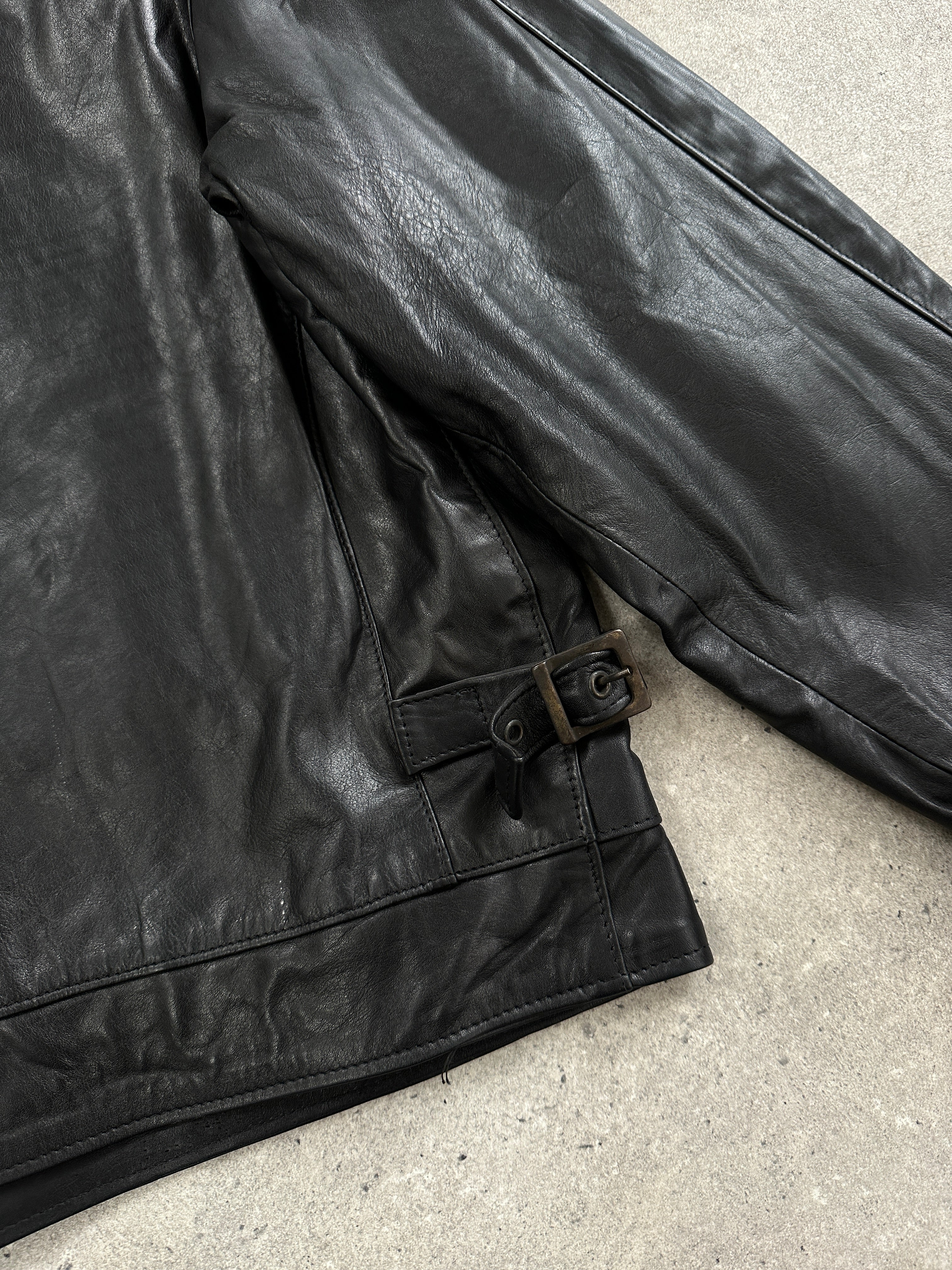 Vintage 1990s boxy cropped leather jacket, size large, featuring a classic black leather design with a slightly worn finish.