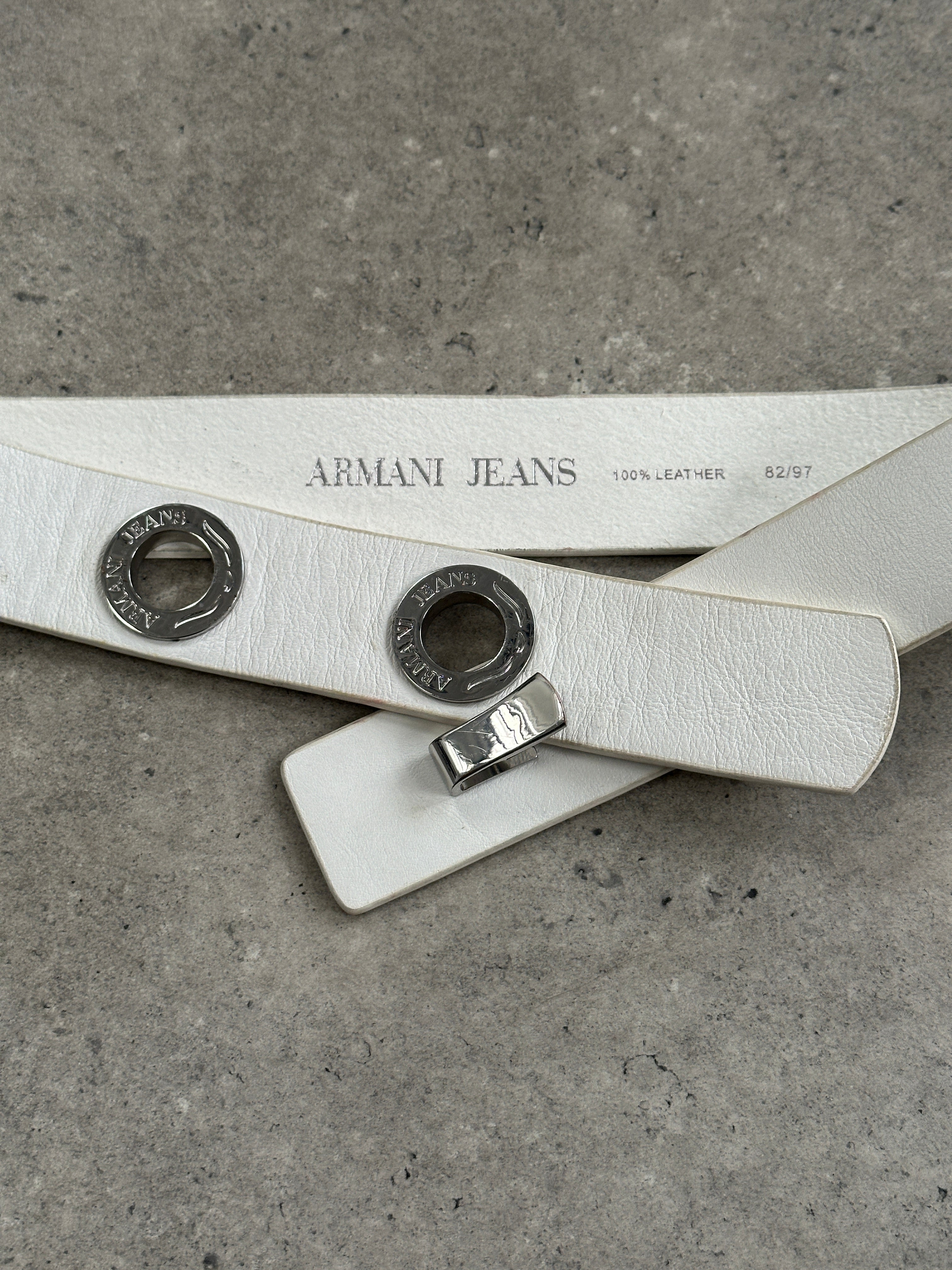Armani Jeans 1990s silver leather belt with eyelet logo detail, adjustable W26-32, stylish men's accessory.