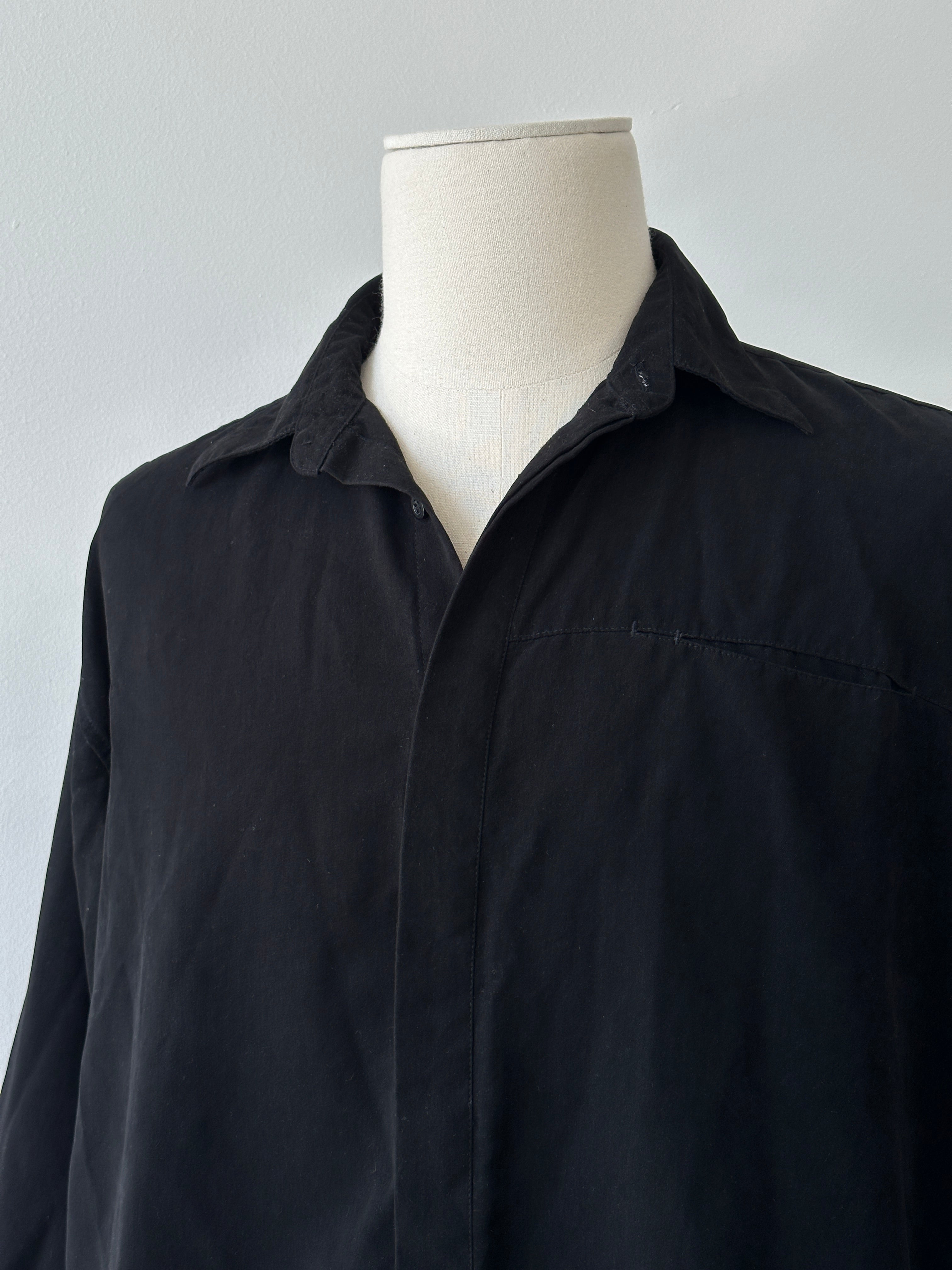 Vintage 1990s concealed placket shirt in size large, featuring a classic design and soft fabric, displayed on a hanger.