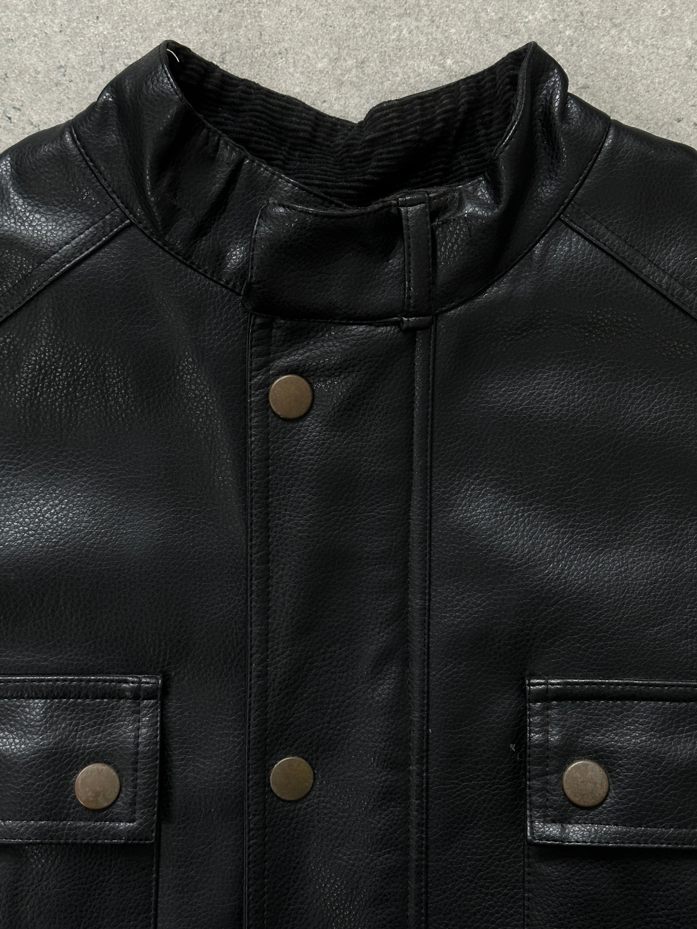 Vintage 1990s boxy faux leather jacket in size M, featuring a classic collar and textured black faux leather material.