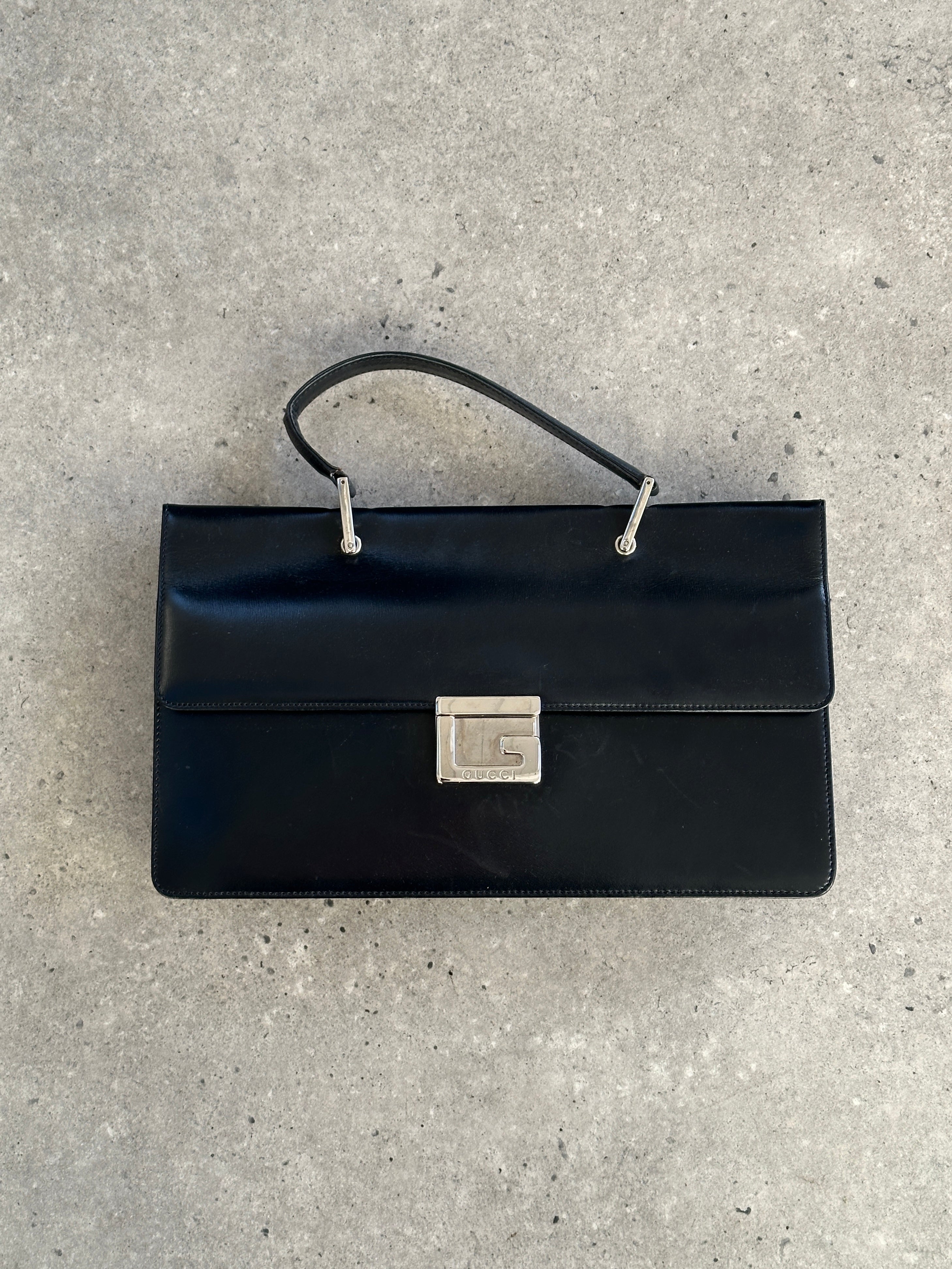 Gucci 1990s Tom Ford Square G leather handbag with structured design and gold-tone hardware, showcasing luxury craftsmanship.