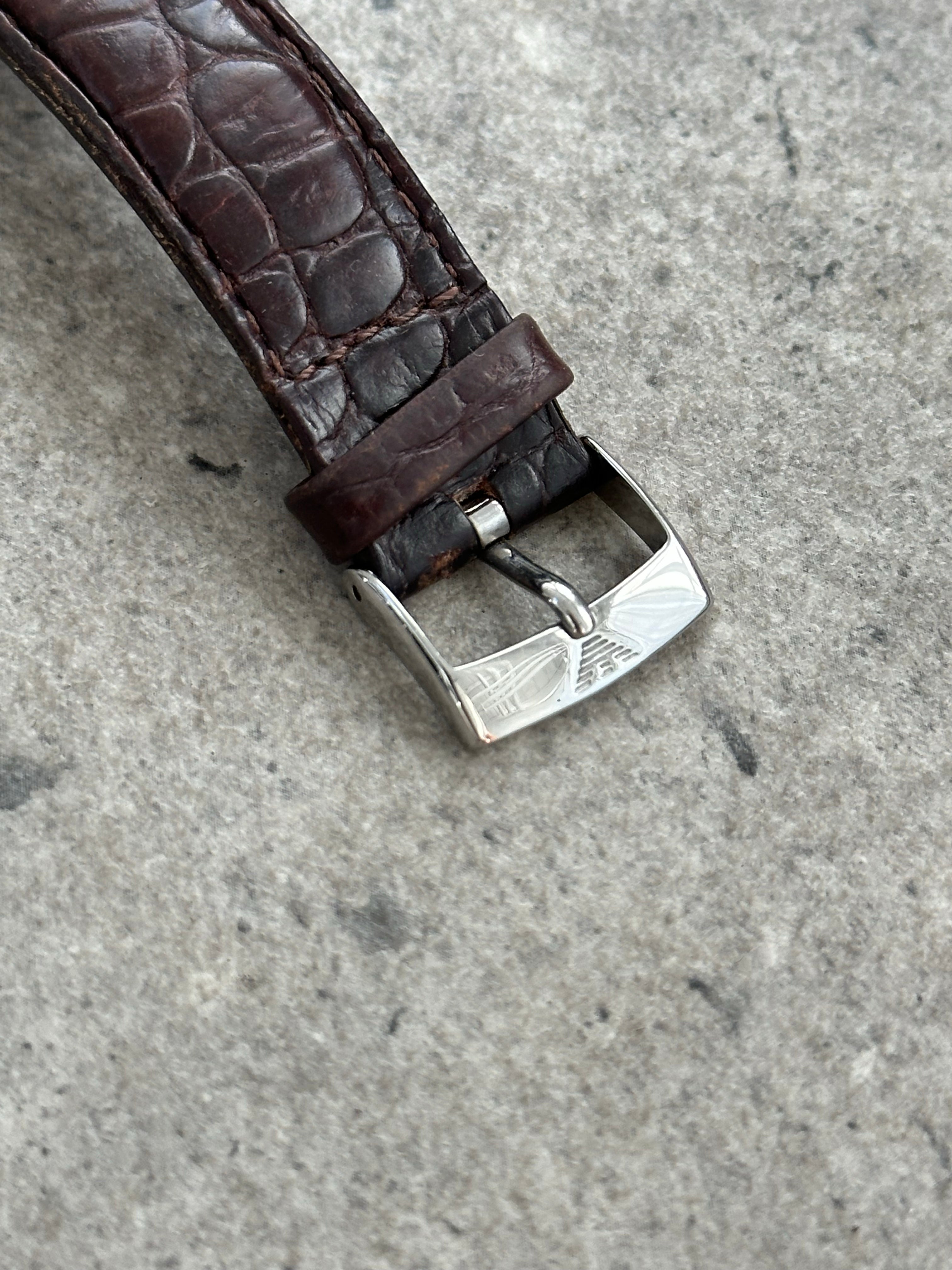 Emporio Armani 2000s leather logo watch with black dial, silver case, and leather strap, showcasing classic Armani style.