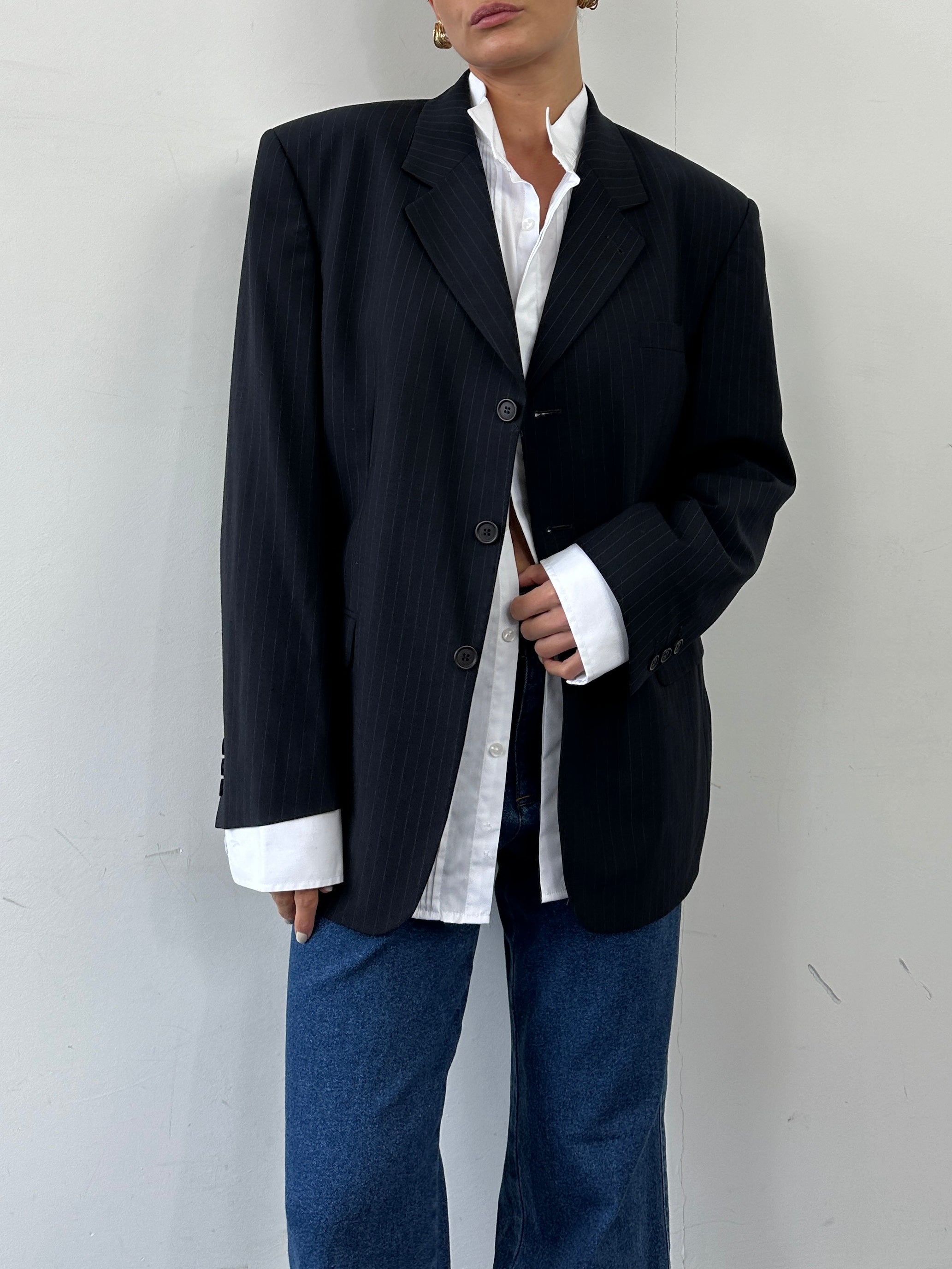 Vintage pinstripe wool single-breasted blazer in size 44S/XL, featuring classic lapels and tailored fit on a hanger.