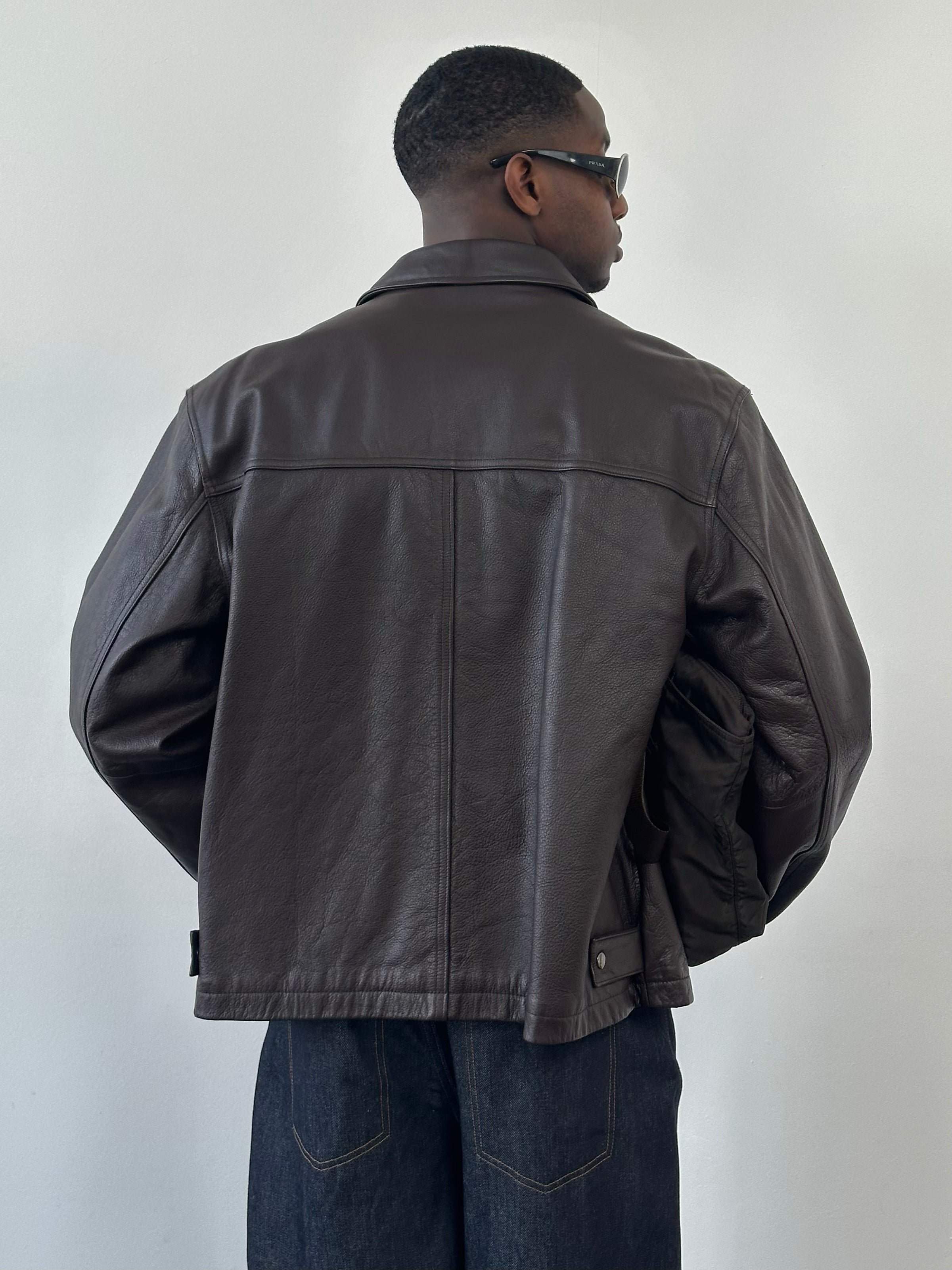 Vintage 1990s boxy leather jacket in XL, featuring minimal design and classic black leather with a slightly worn look.