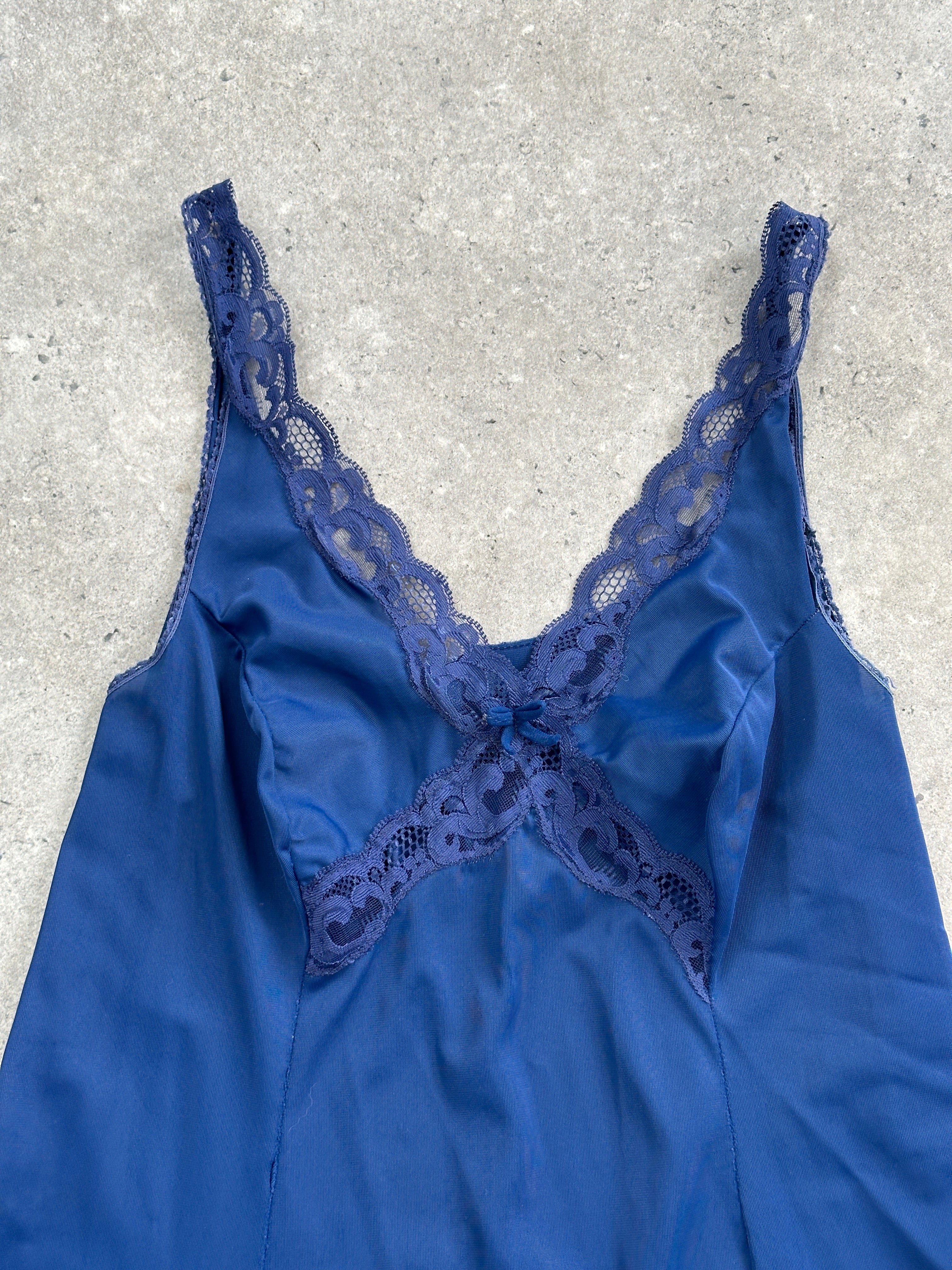 Vintage 1980s lace sheer mini slip dress in size small with delicate floral lace and lightweight fabric, perfect for retro-inspired fashion.