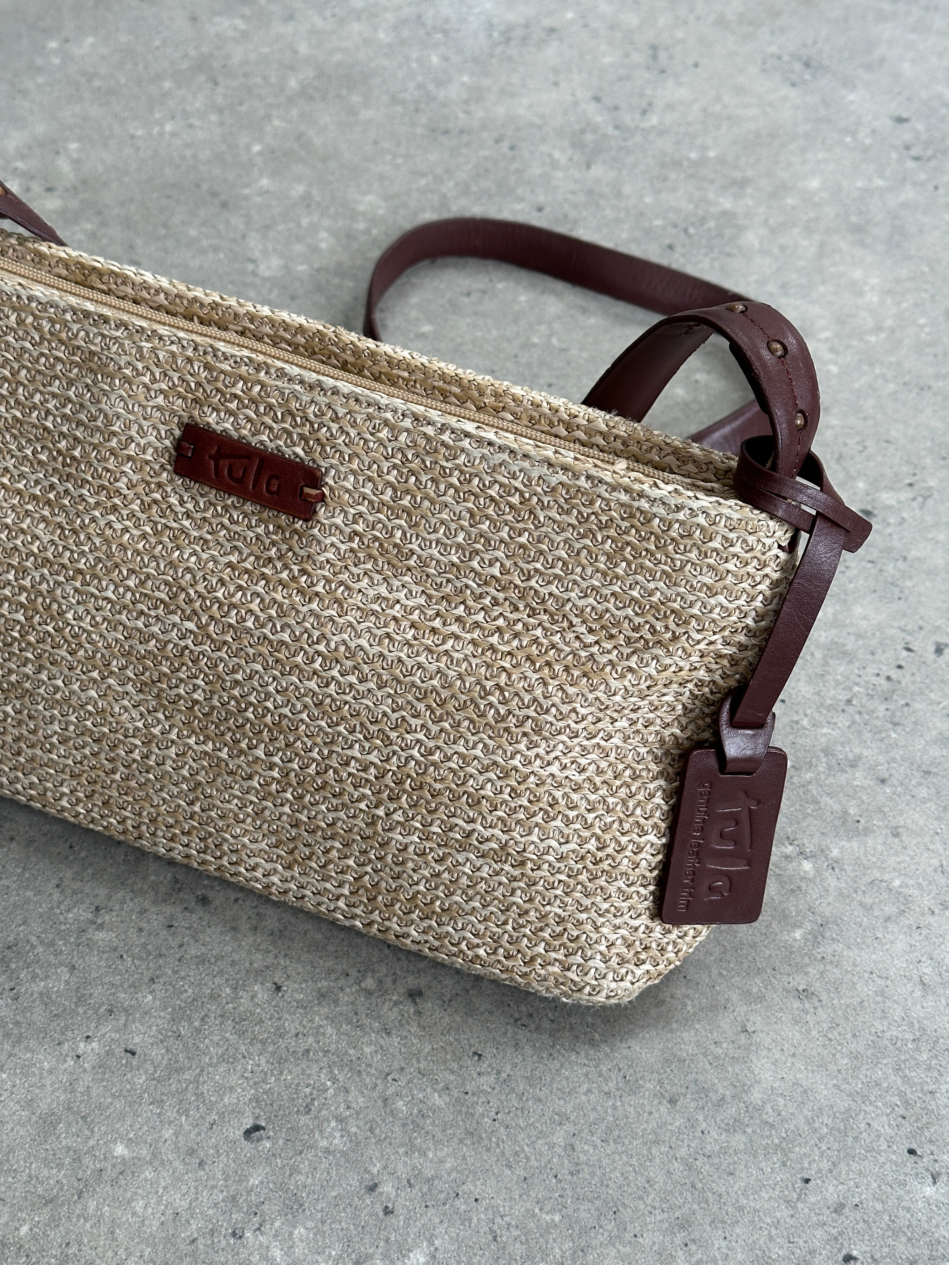 Vintage Raffia Crossbody Bag with woven design, featuring a compact shape and adjustable strap for casual and stylish wear.