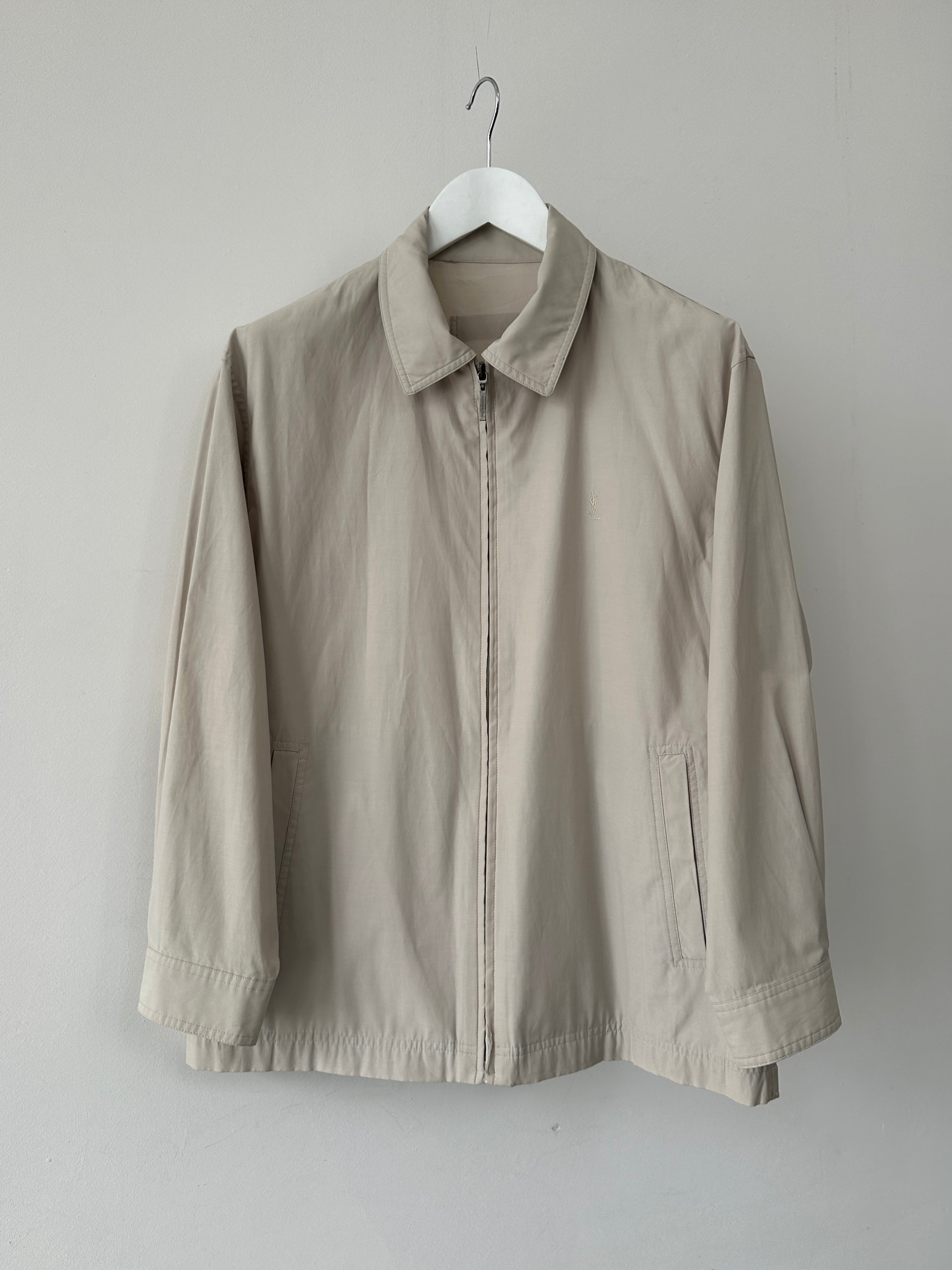 Yves Saint Laurent Pour Homme logo bomber jacket in black with front zipper and ribbed cuffs, size M/L, displayed on a hanger.